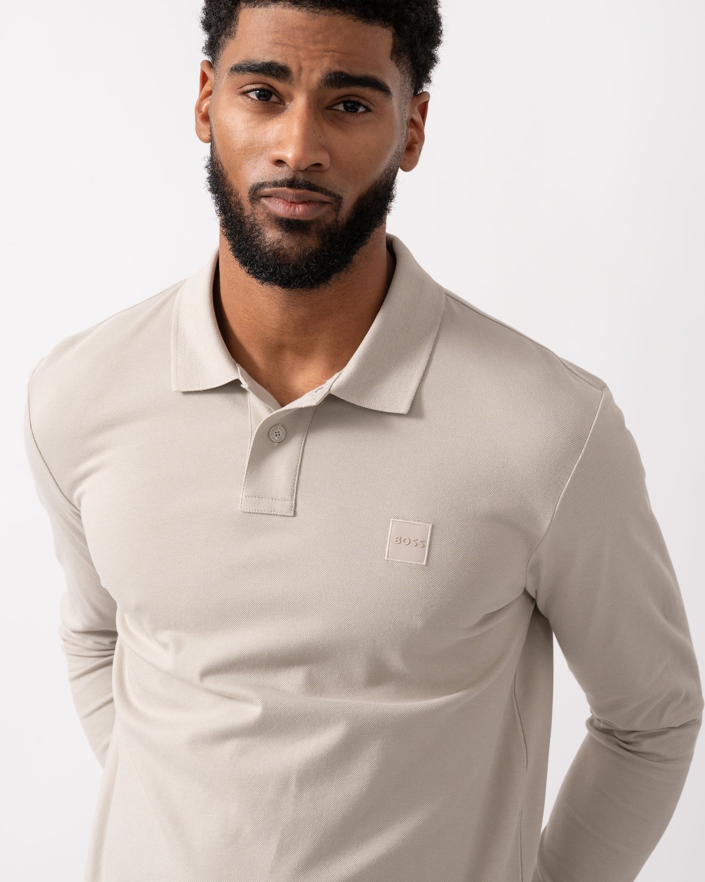 detail shot of a model wearing a BOSS Orange Passerby Mens Long Sleeve Stretch-Cotton Polo Shirt with Logo Patch in Open Grey
