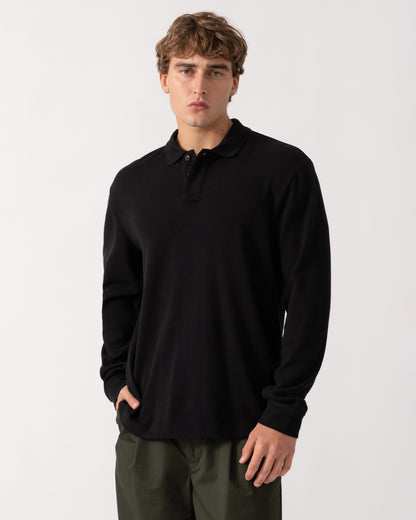 Model wearing BOSS Orange Petempestolong Mens Long Sleeve Polo Shirt - Black 001