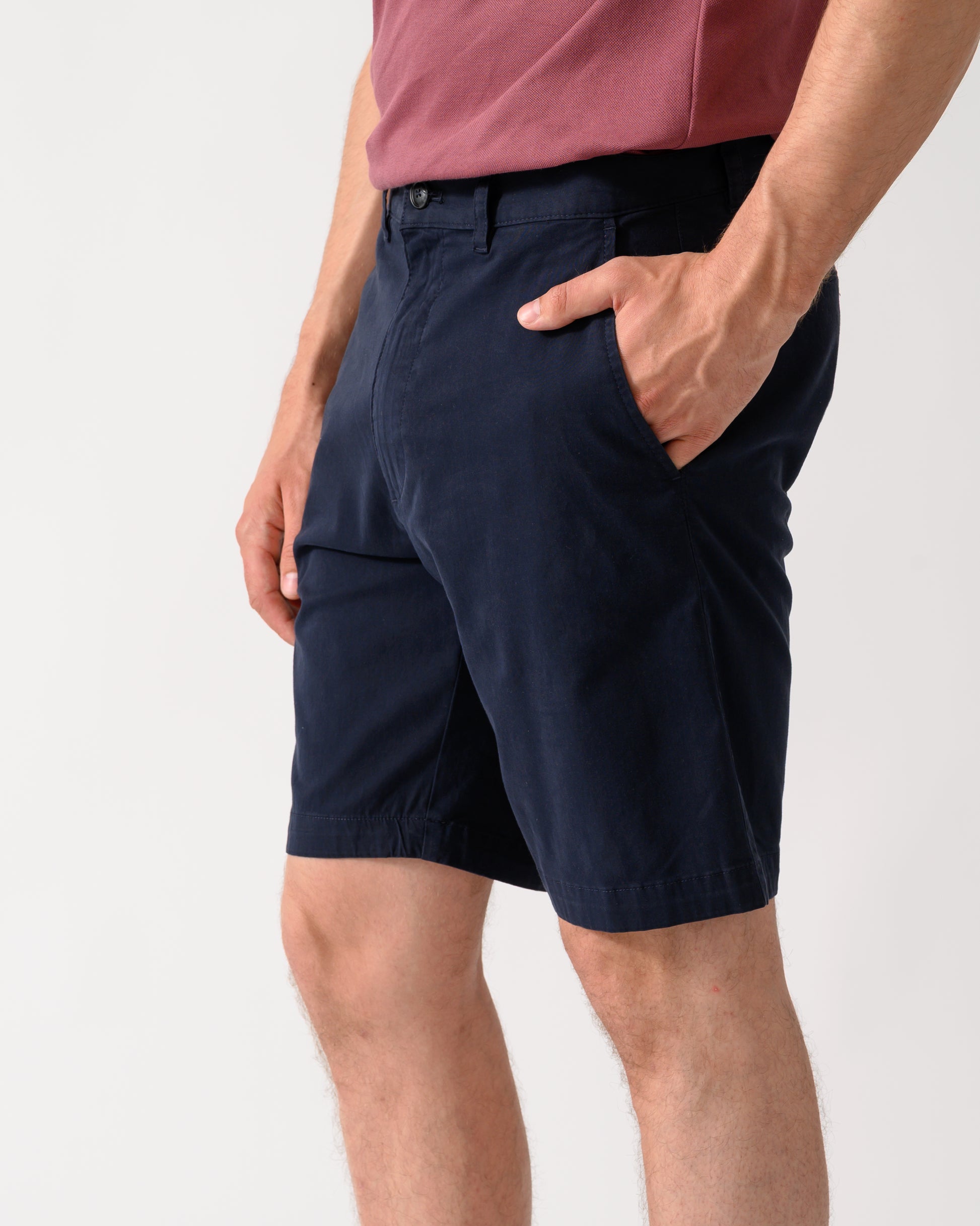 side shot of model wearing a pair of BOSS Orange Slim Fit Mens Chino Shorts in Dark Blue 404
