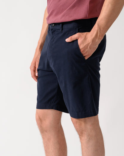 side shot of model wearing a pair of BOSS Orange Slim Fit Mens Chino Shorts in Dark Blue 404