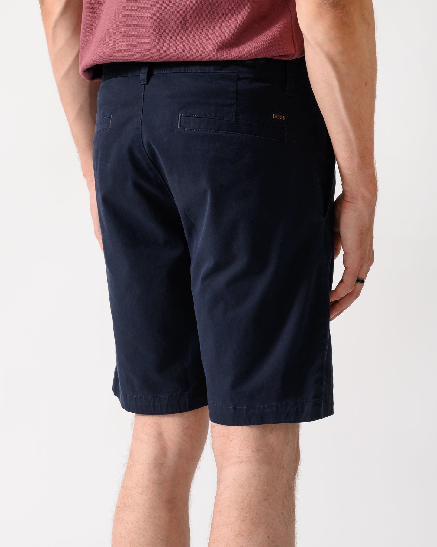 back shot of model wearing a pair of BOSS Orange Slim Fit Mens Chino Shorts in Dark Blue 404