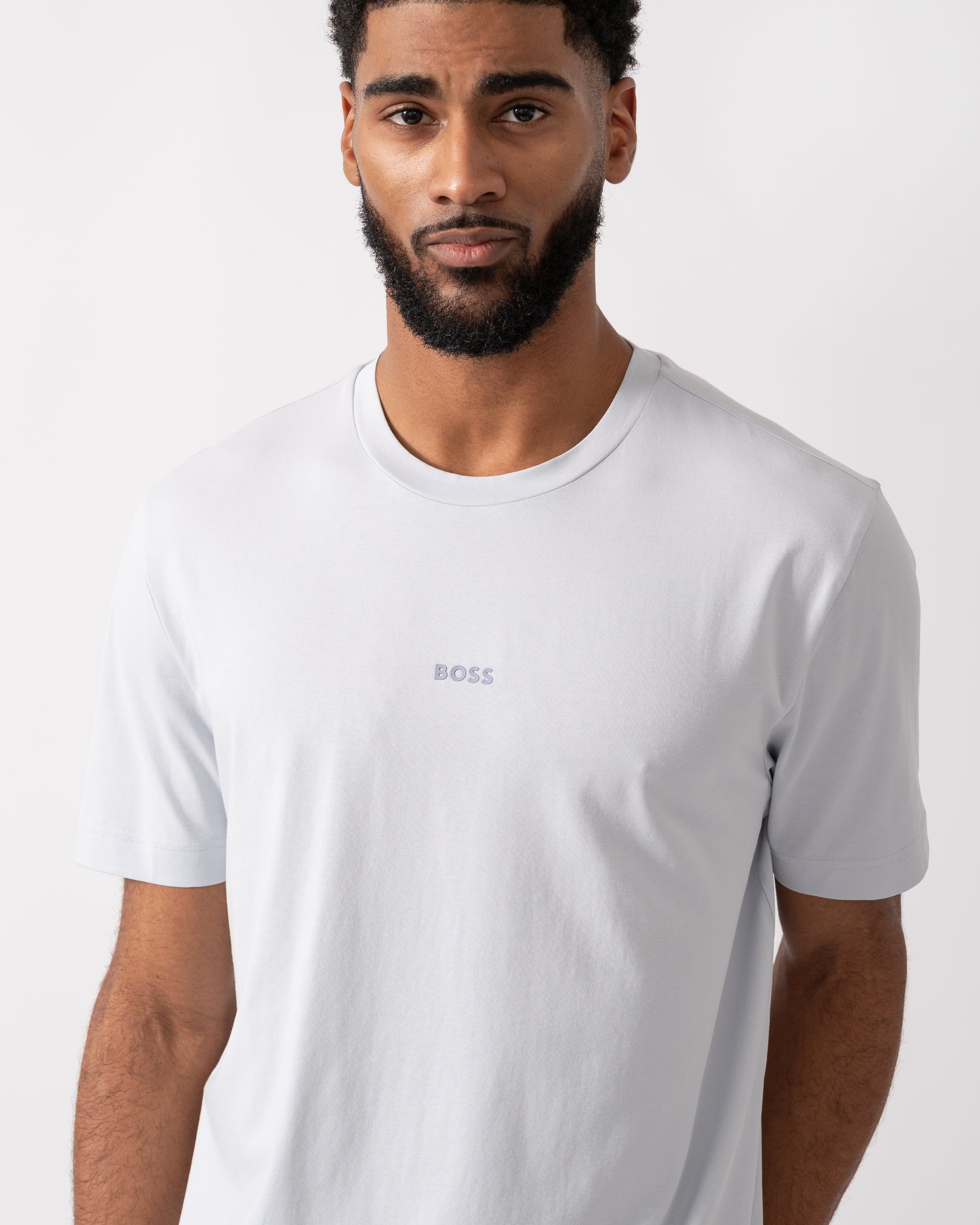 detail shot of a model wearing a BOSS Orange TChup Mens Crew Neck Small Logo T-Shirt in Light-Pastel Grey