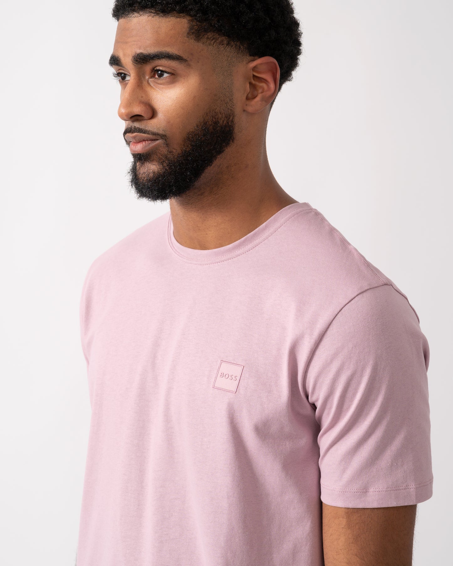 detail shot of a Model wearing a BOSS Orange Tales Mens Cotton-Jersey T-shirt With Logo Patch in Light Pastel Purple