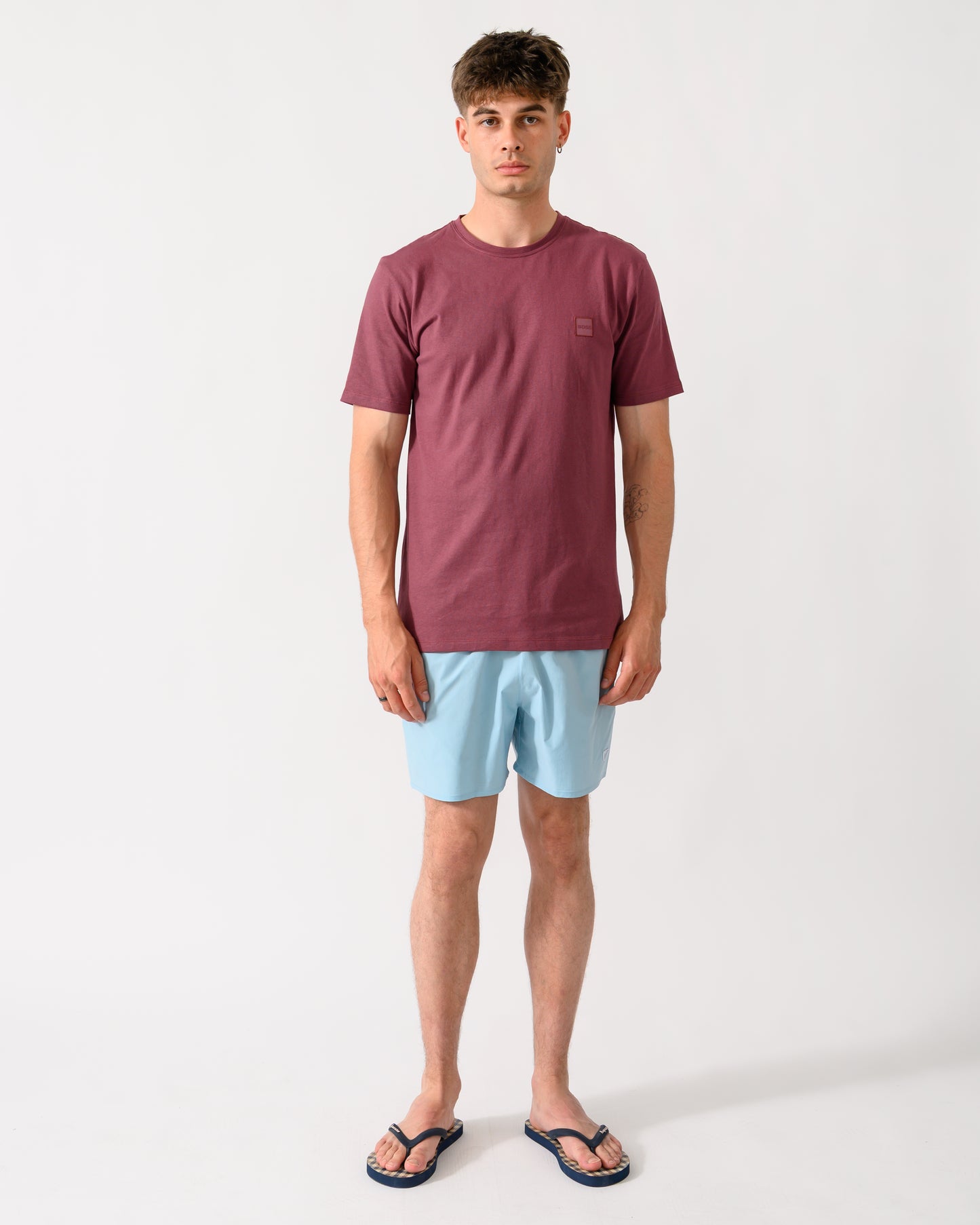 full length shot of a model wearing a BOSS Orange Tales Mens Cotton-Jersey T-shirt With Logo Patch in Medium Red 618