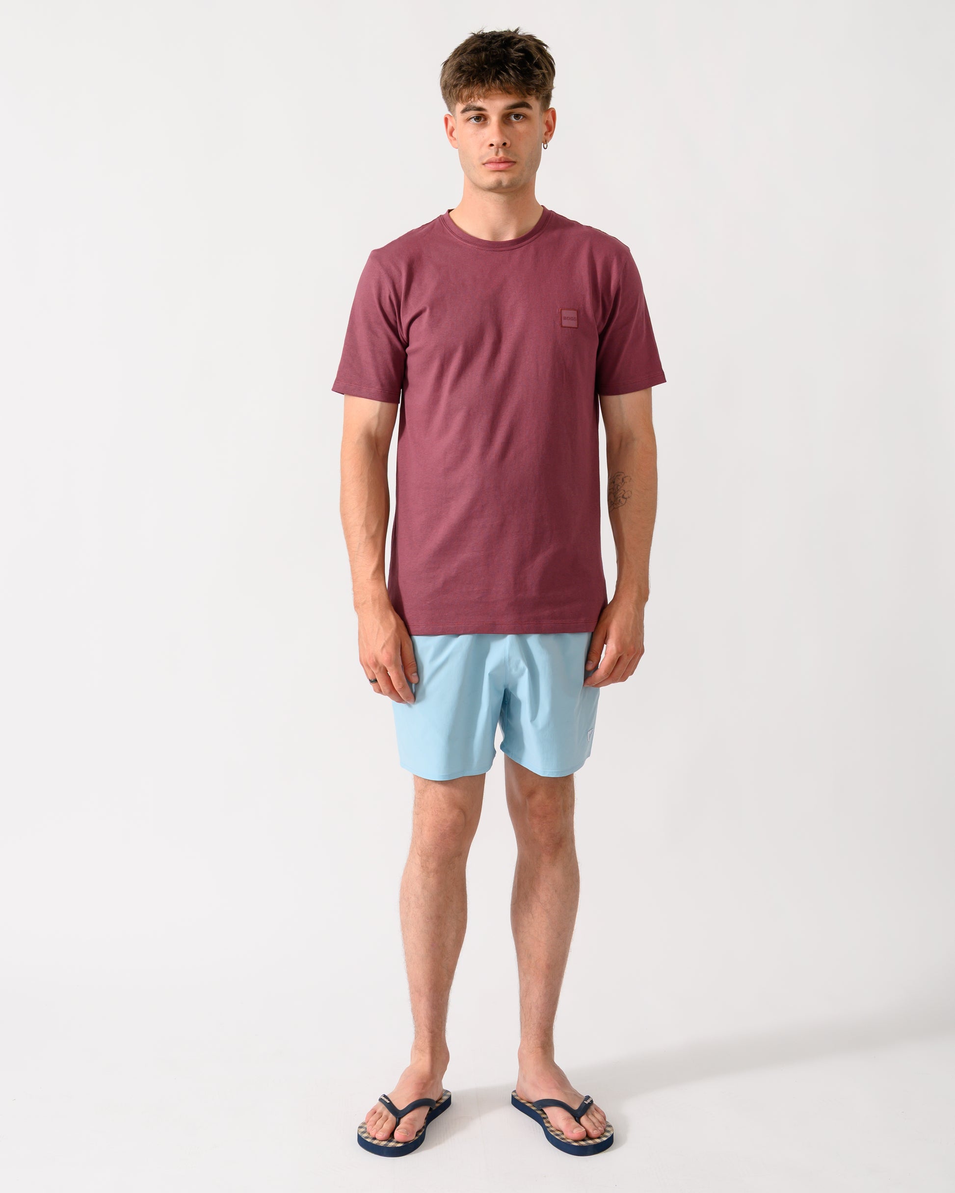 full length shot of a model wearing a BOSS Orange Tales Mens Cotton-Jersey T-shirt With Logo Patch in Medium Red 618