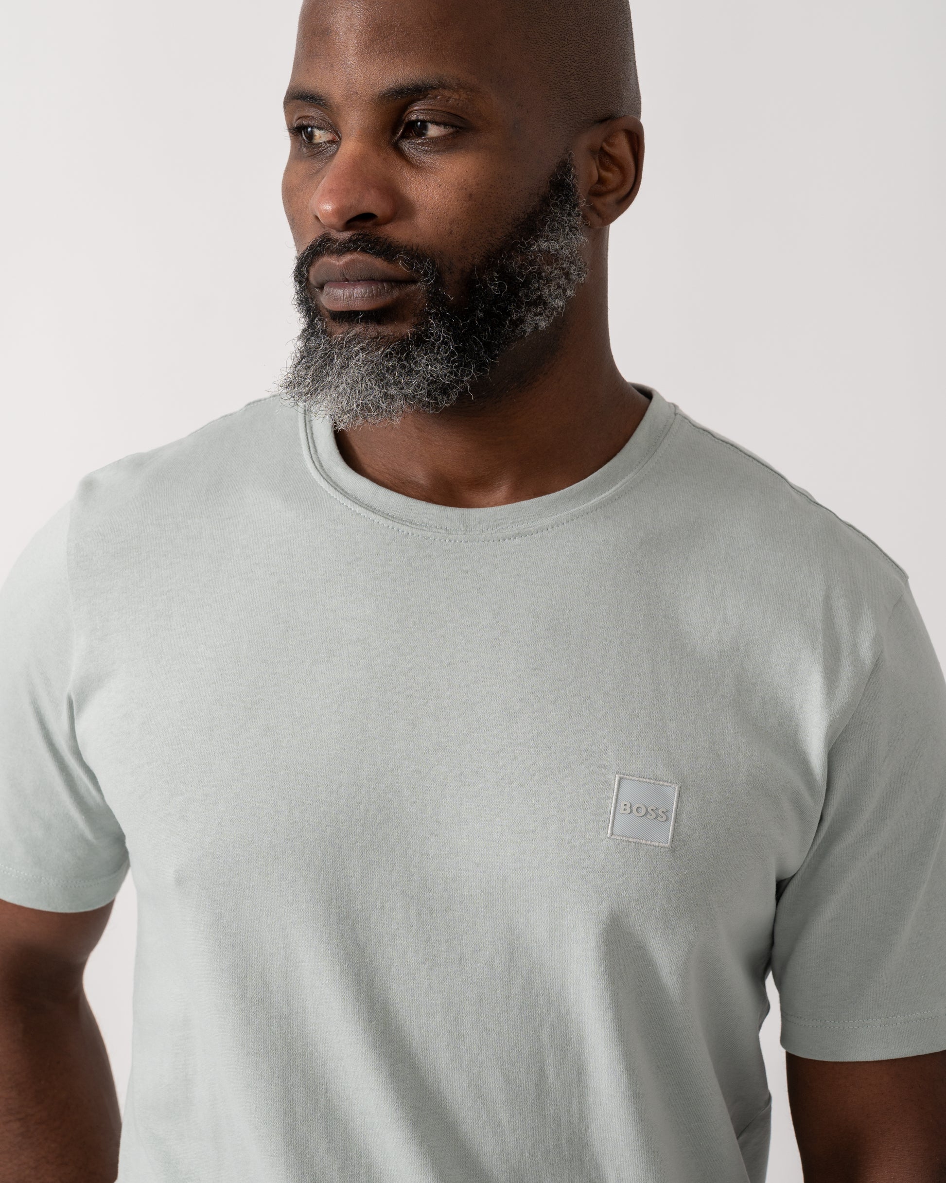 detail shot of a model wearing a BOSS Orange Tales Mens Cotton-Jersey T-shirt With Logo Patch in Silver