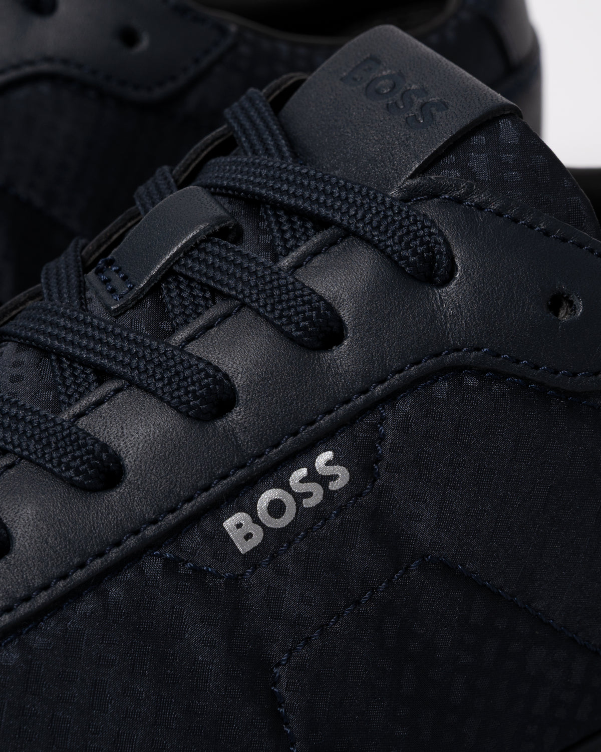 Studio photograph showing close up of BOSS Orange Vinston_Runn_nymnlt Mens Trainers in Dark Blue 405