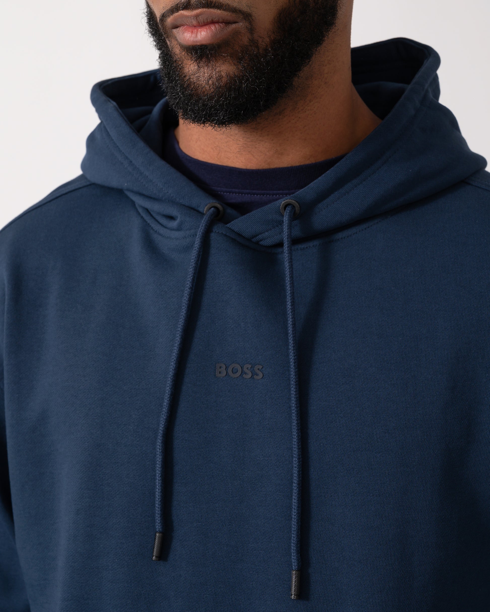 close up of a Model wearing a BOSS Orange WeSmallhood Mens Hoodie in Open Blue