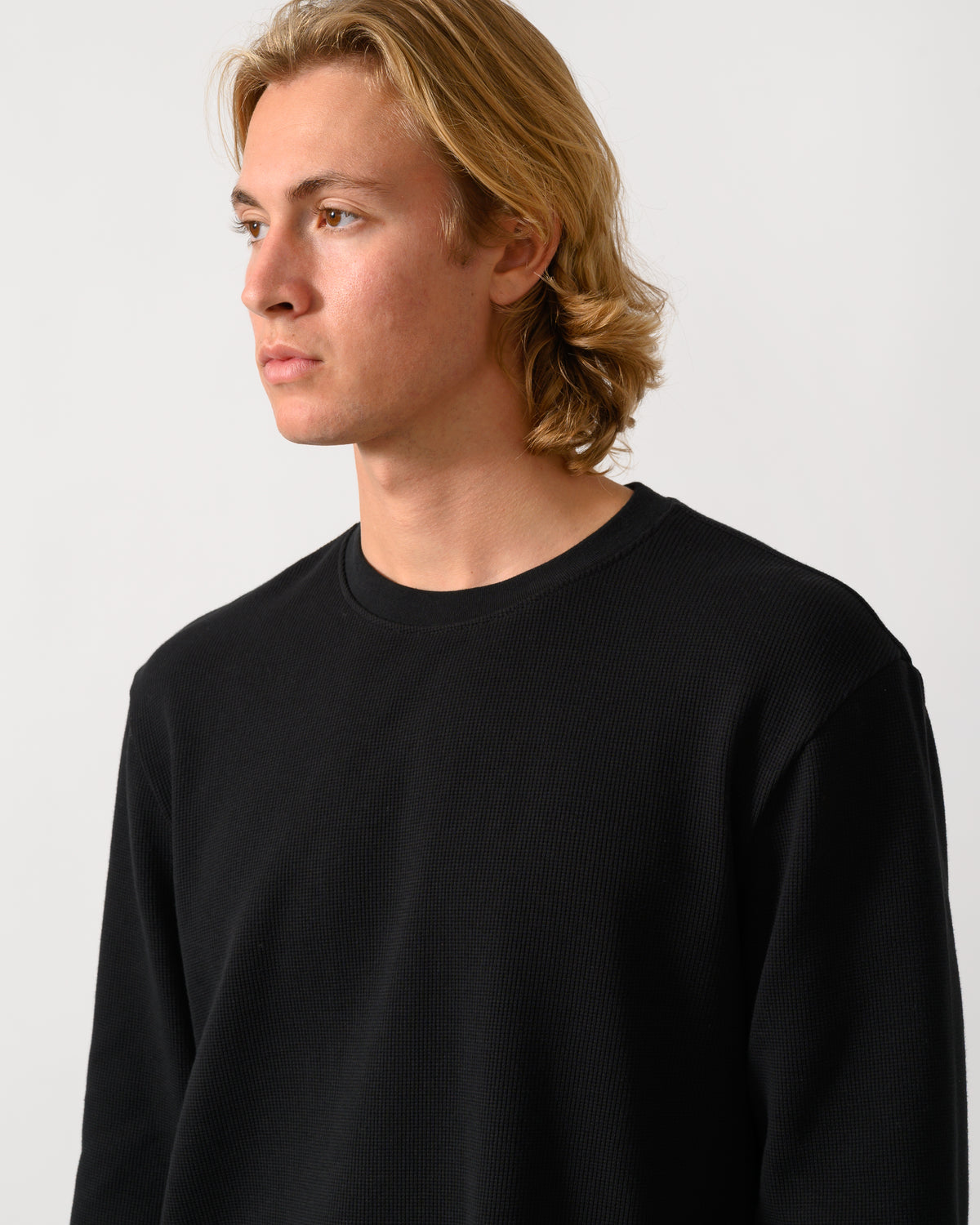 close up studio photograph of a model wearing a BOSS Orange We Tempest Mens Crew Neck Sweatshirt in Black 001