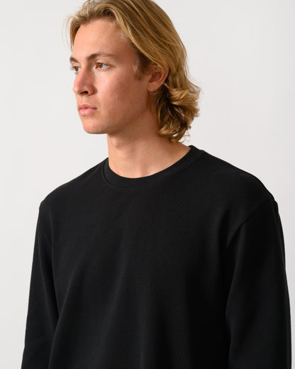 close up studio photograph of a model wearing a BOSS Orange We Tempest Mens Crew Neck Sweatshirt in Black 001