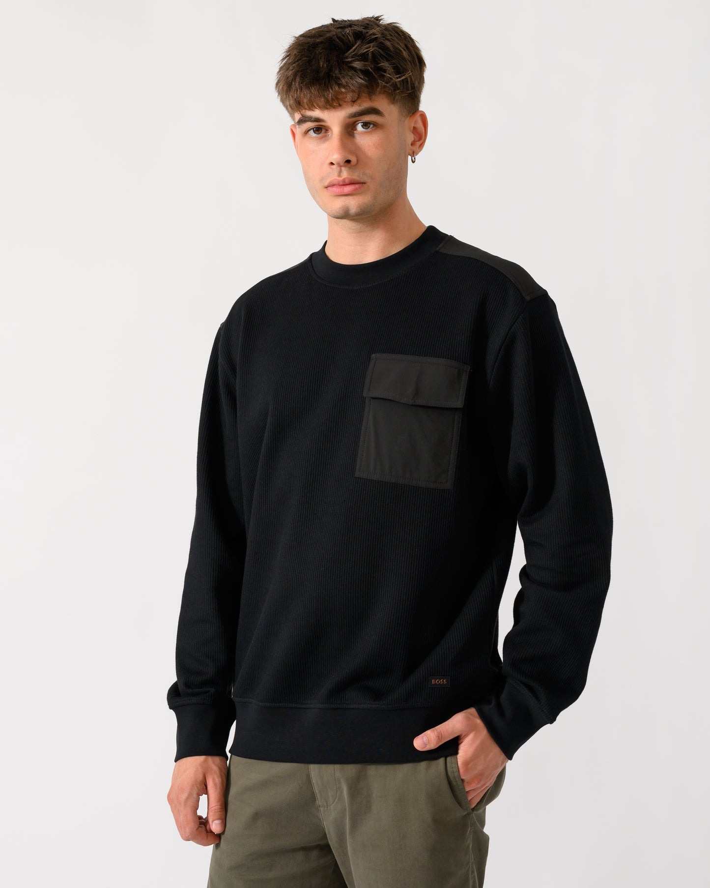 model wearing a BOSS Orange We Urban Mens Crew Neck Sweatshirt with Pocket in Black 001