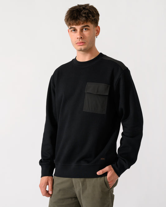 model wearing a BOSS Orange We Urban Mens Crew Neck Sweatshirt with Pocket in Black 001