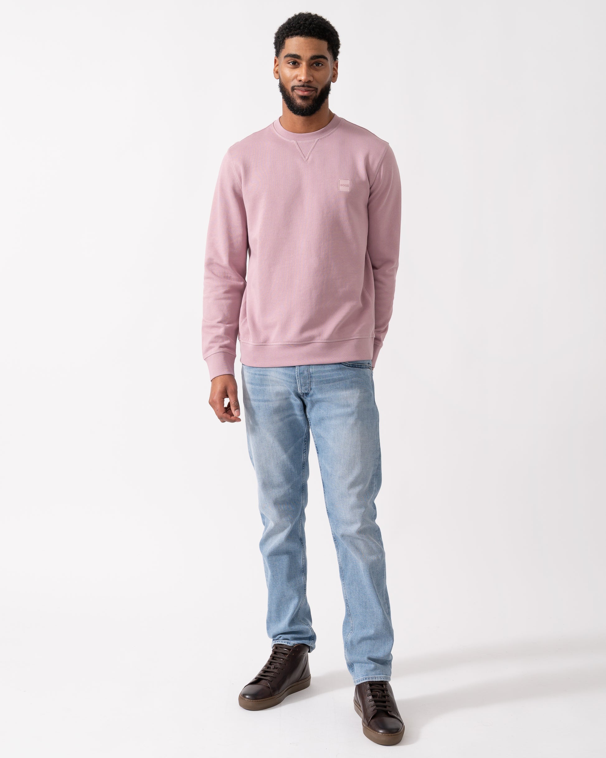 full length shot of a model wearing a BOSS Orange Westart Mens Crew Neck Sweatshirt With Logo Patch in Light Pastel Purple