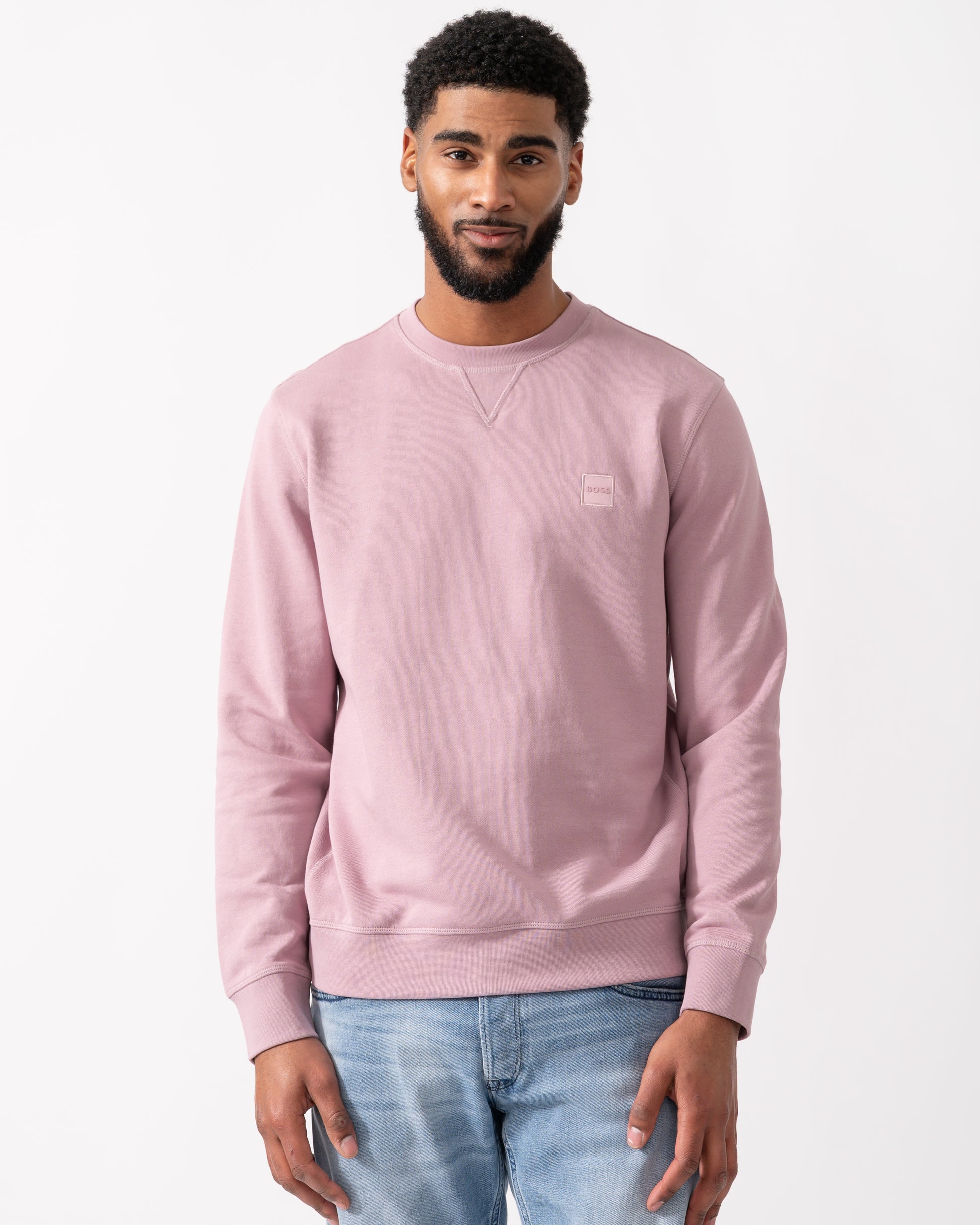 model wearing a BOSS Orange Westart Mens Crew Neck Sweatshirt With Logo Patch in Light Pastel Purple