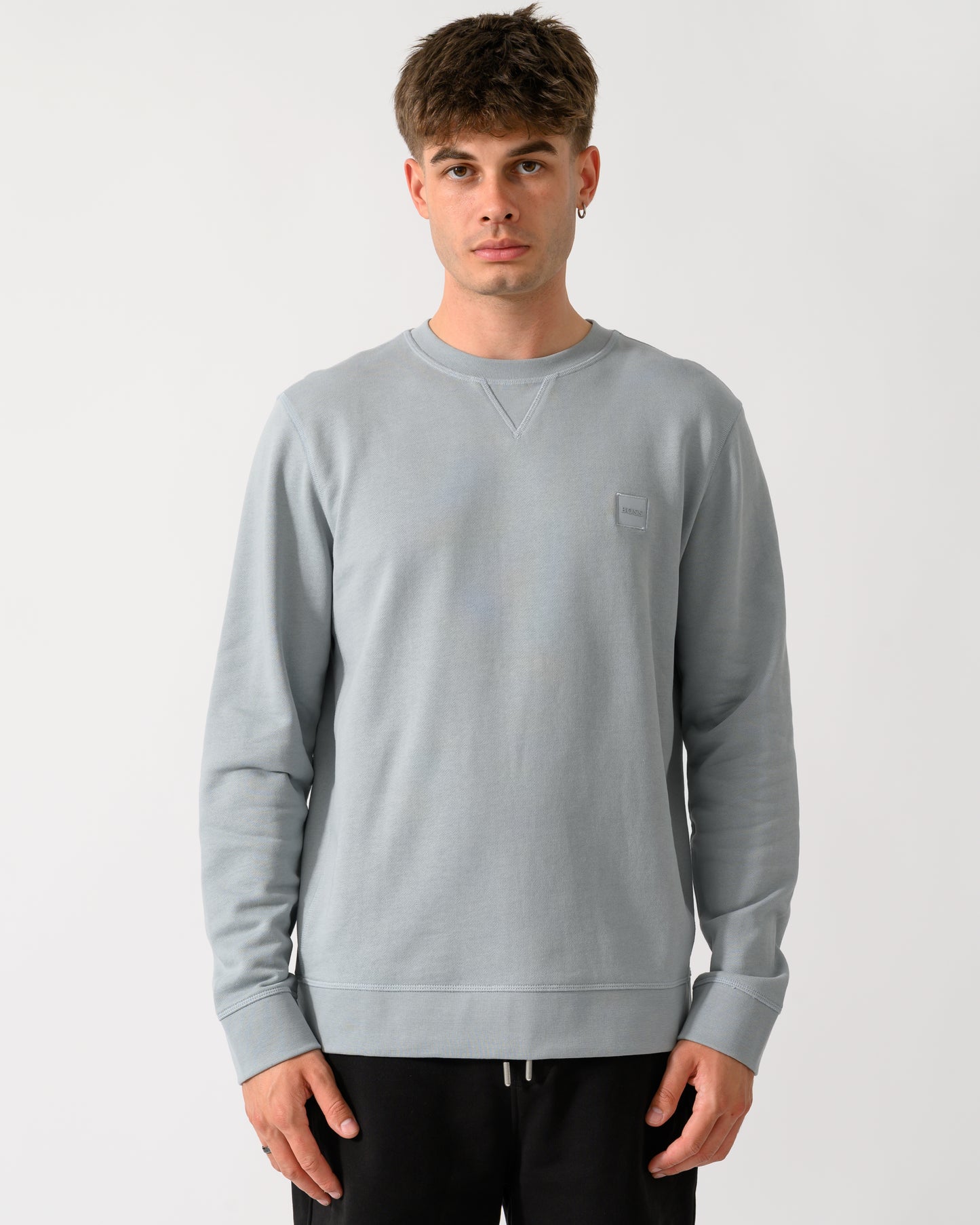 model wearing a BOSS Orange Westart Mens Crew Neck Sweatshirt With Logo Patch in Open Grey 084