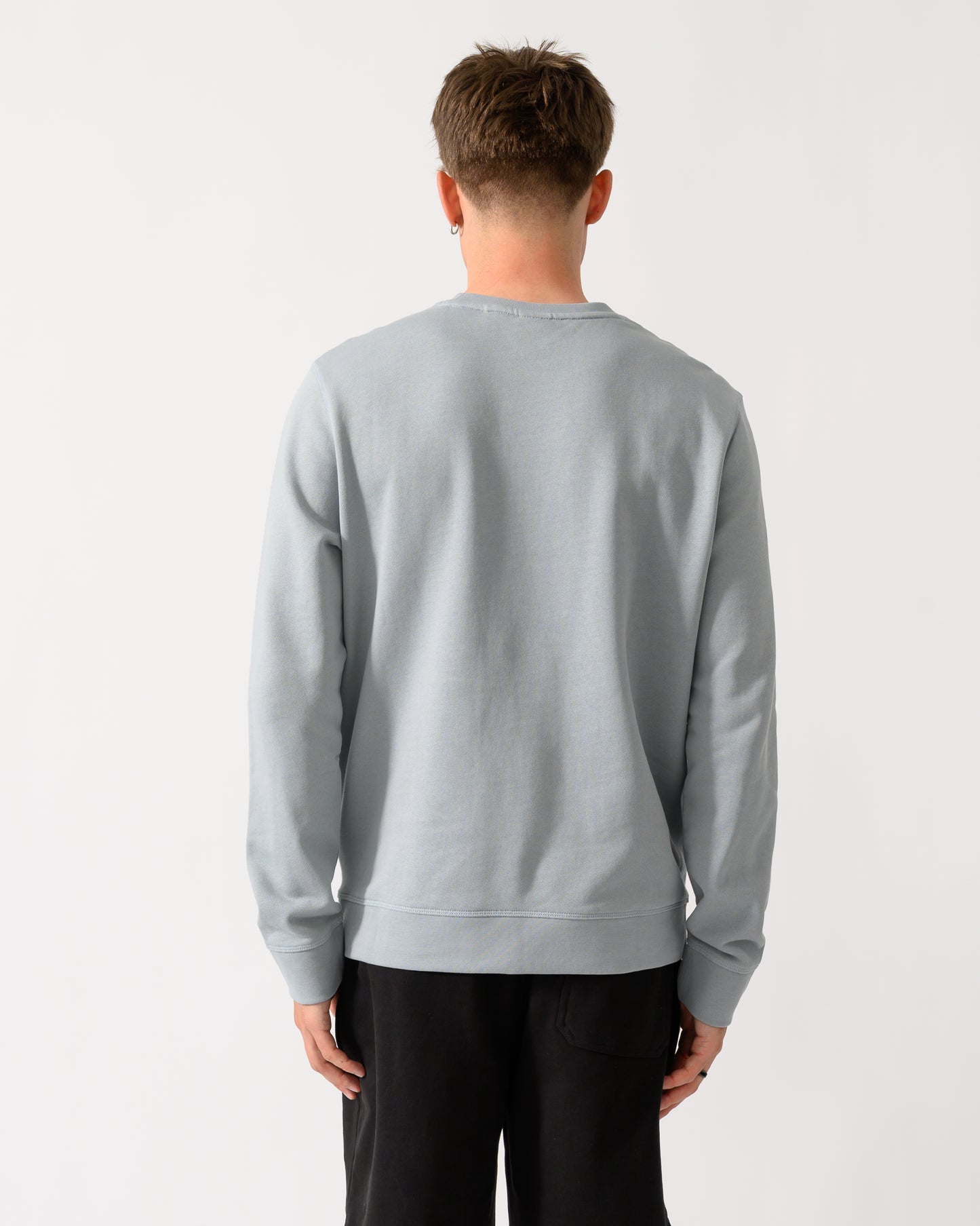 back shot of a model wearing a BOSS Orange Westart Mens Crew Neck Sweatshirt With Logo Patch in Open Grey 084