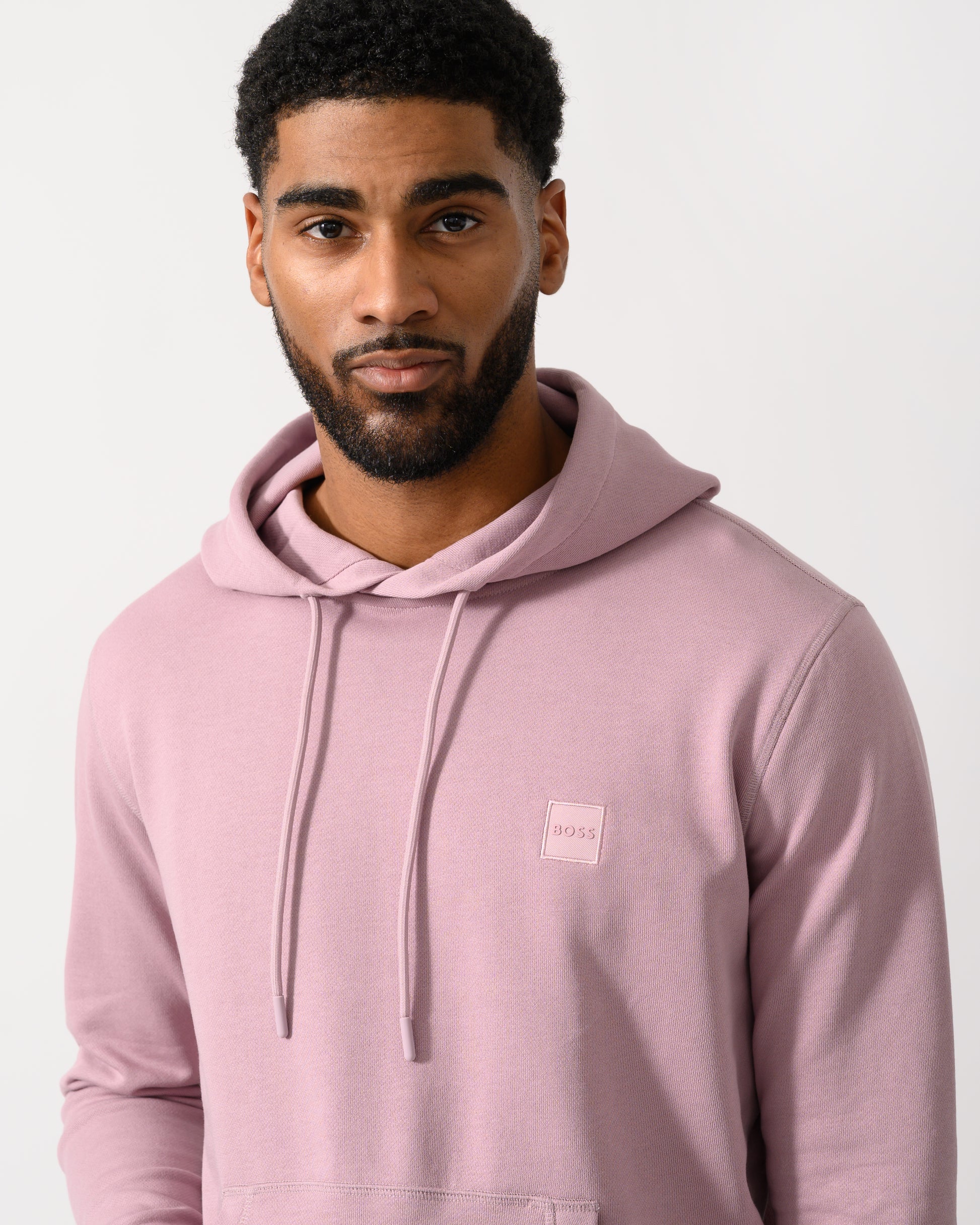 Detail shot of a Model wearing a BOSS Orange Wetalk Mens Pullover Hoodie With Logo Patch in Light/Pastel Purple