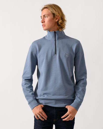 model wearing a BOSS Orange Zetrust Mens 1/4 Zip Sweatshirt in Medium Blue 424