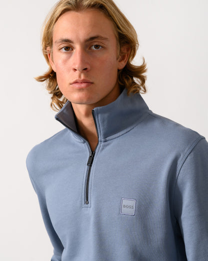 close up of a model wearing a BOSS Orange Zetrust Mens 1/4 Zip Sweatshirt in Medium Blue 424