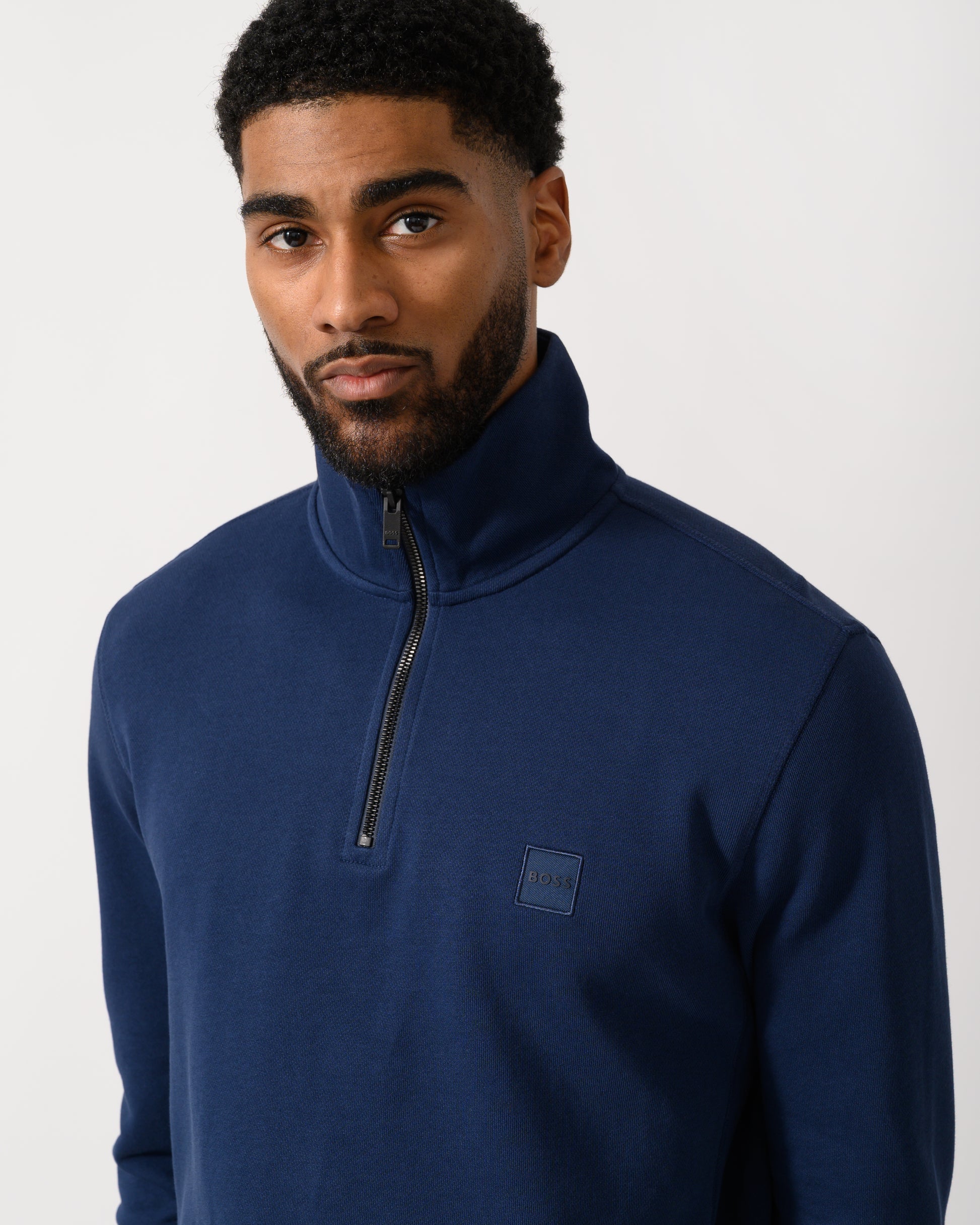 detail shot of a Model wearing a BOSS Orange Zetrust Mens 1/4 Zip Sweatshirt in Open Blue