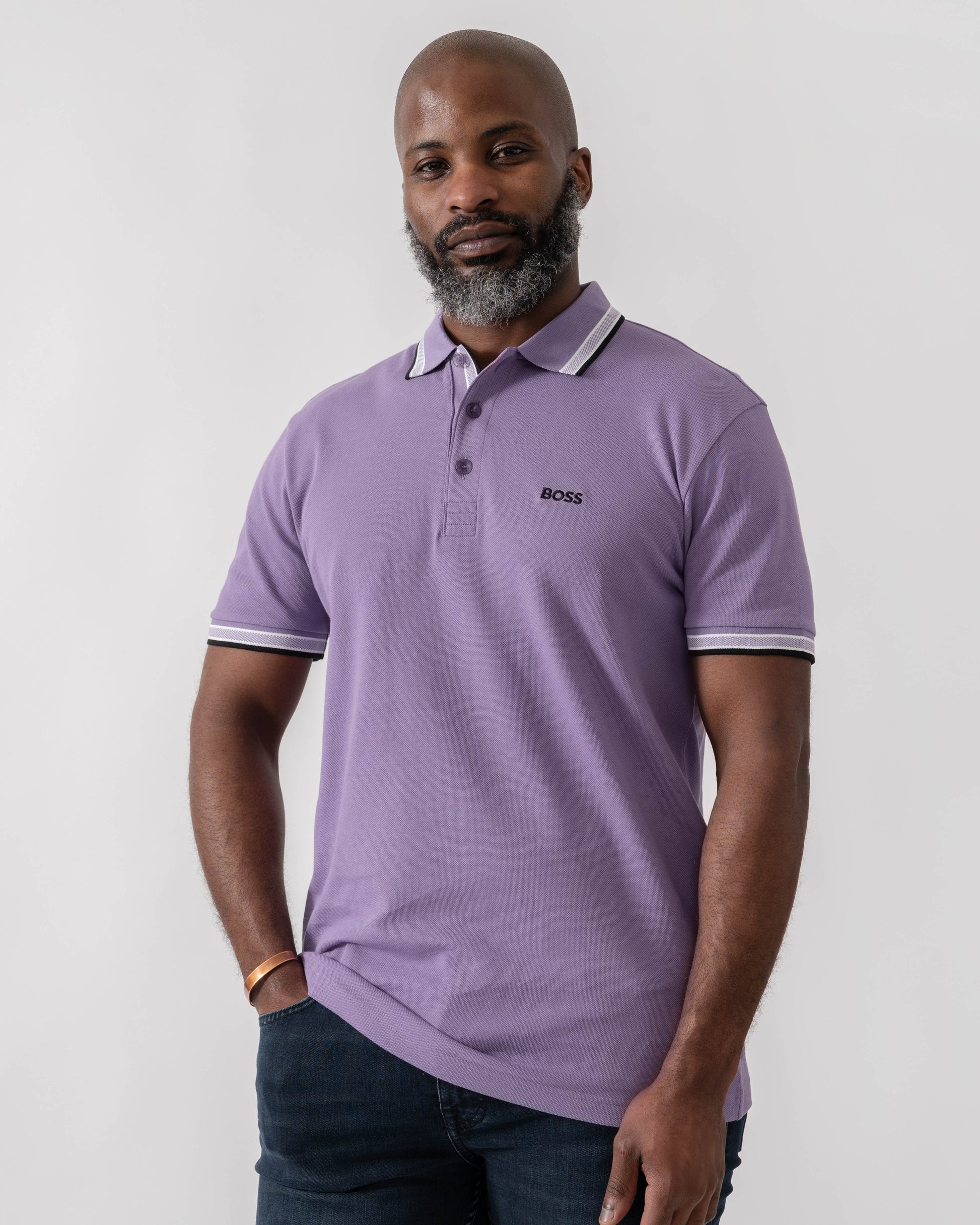 Model wearing BOSS Green Paddy Mens Cotton-Piqué Polo Shirt with Contrast Logo in Bright Purple 521 - Main