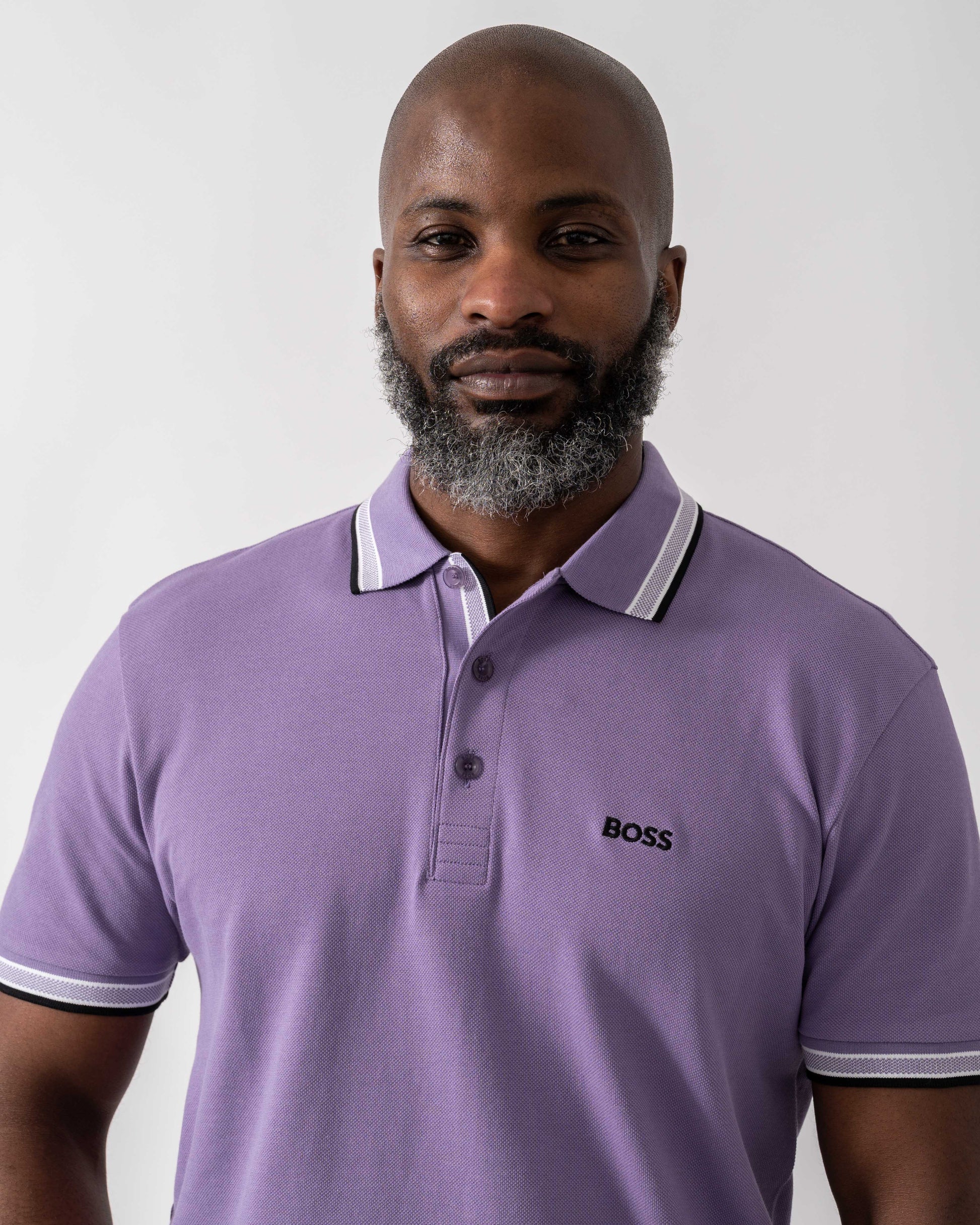 Model wearing BOSS Green Paddy Mens Cotton-Piqué Polo Shirt with Contrast Logo in Bright Purple 521 - Detail