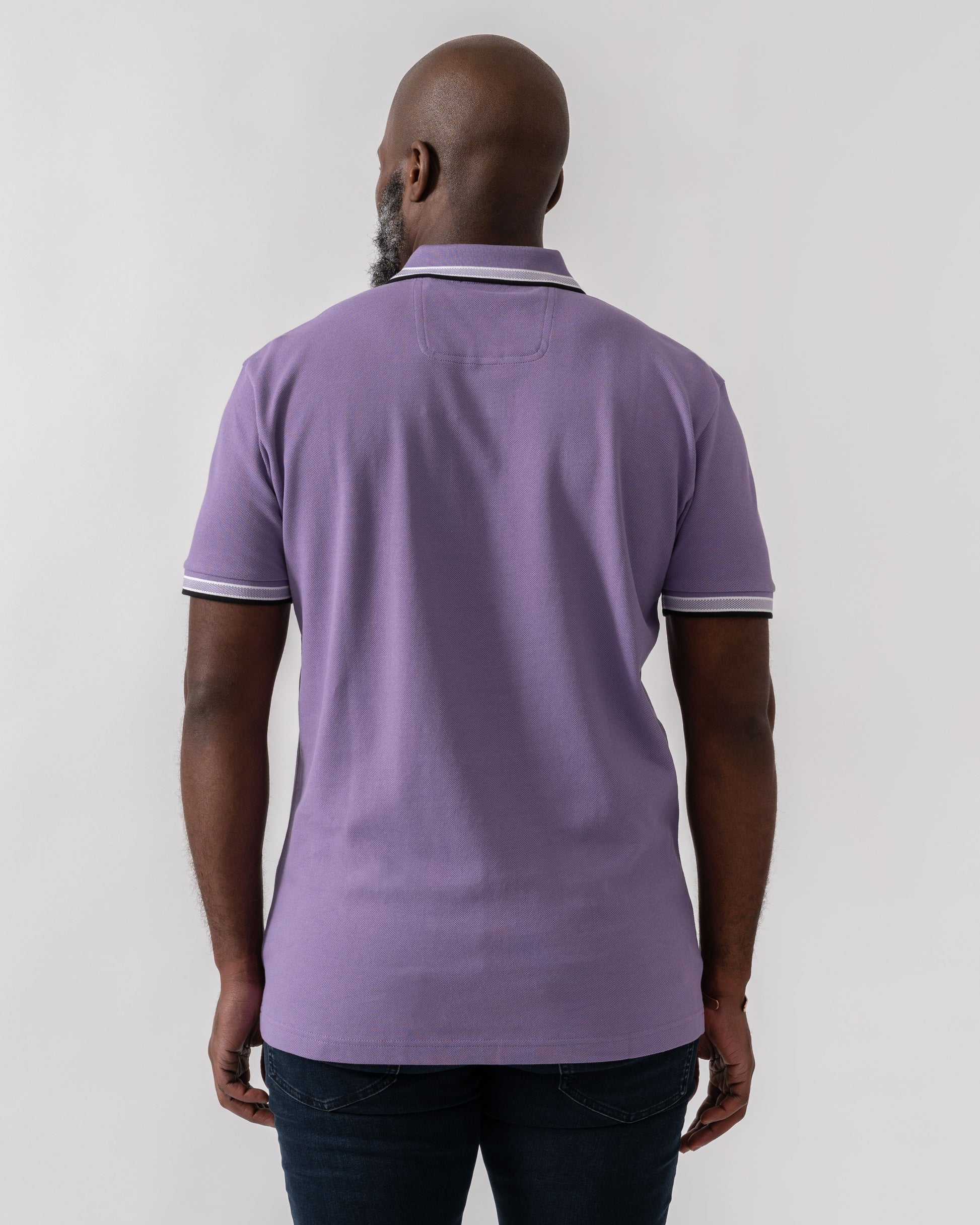 Model wearing BOSS Green Paddy Mens Cotton-Piqué Polo Shirt with Contrast Logo in Bright Purple 521 - Back