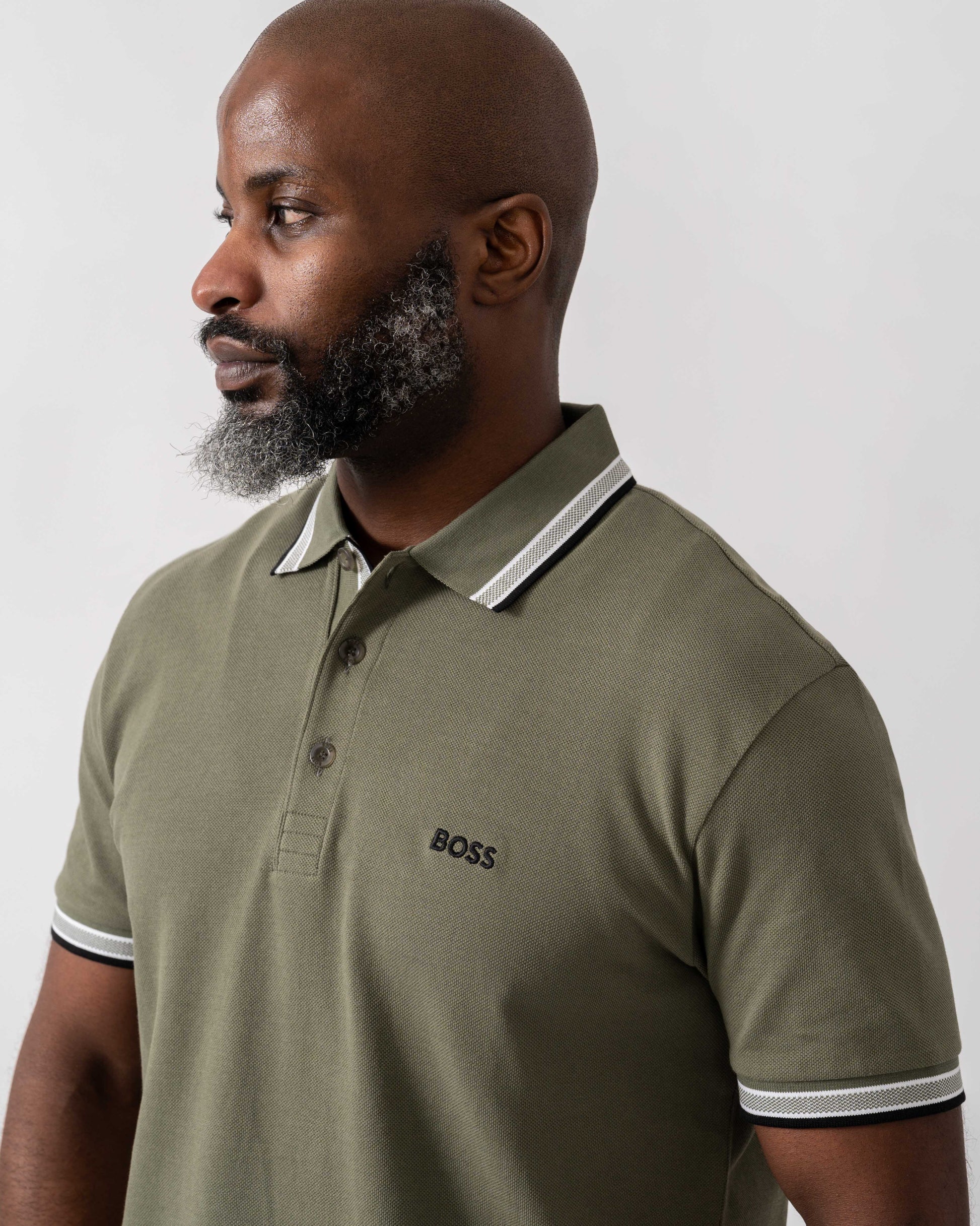 Model wearing BOSS Green Paddy Mens Cotton-Piqué Polo Shirt with Contrast Logo in Dark Beige 258 - Detail