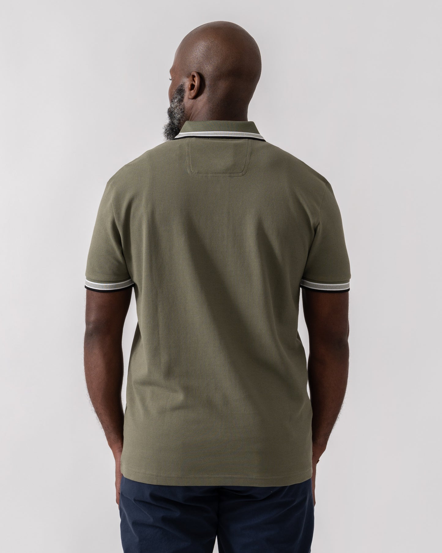 Model wearing BOSS Green Paddy Mens Cotton-Piqué Polo Shirt with Contrast Logo in Dark Beige 258 - Back