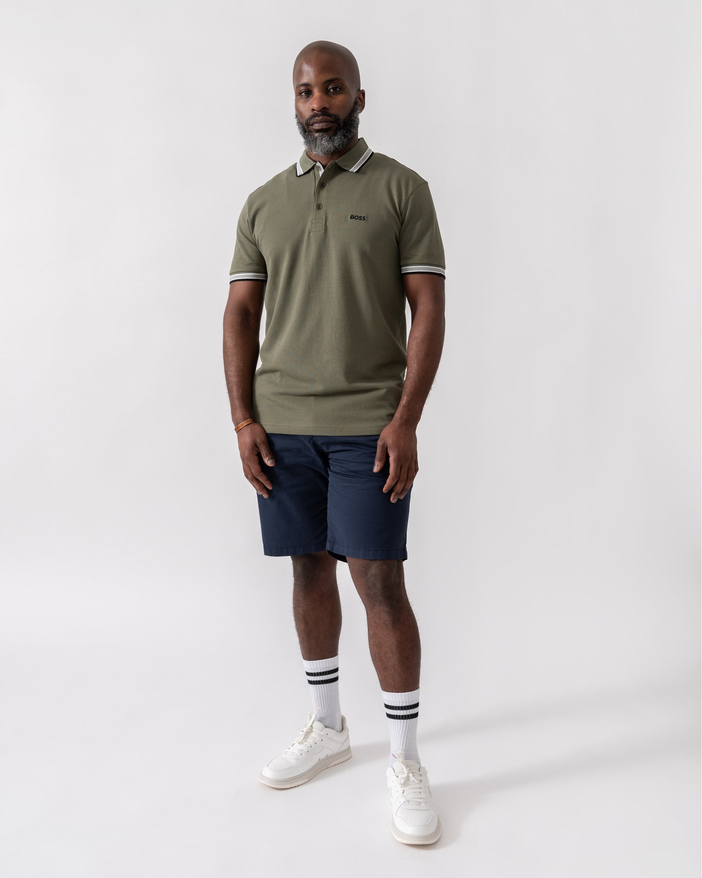Model wearing BOSS Green Paddy Mens Cotton-Piqué Polo Shirt with Contrast Logo in Dark Beige 258 - Full Length