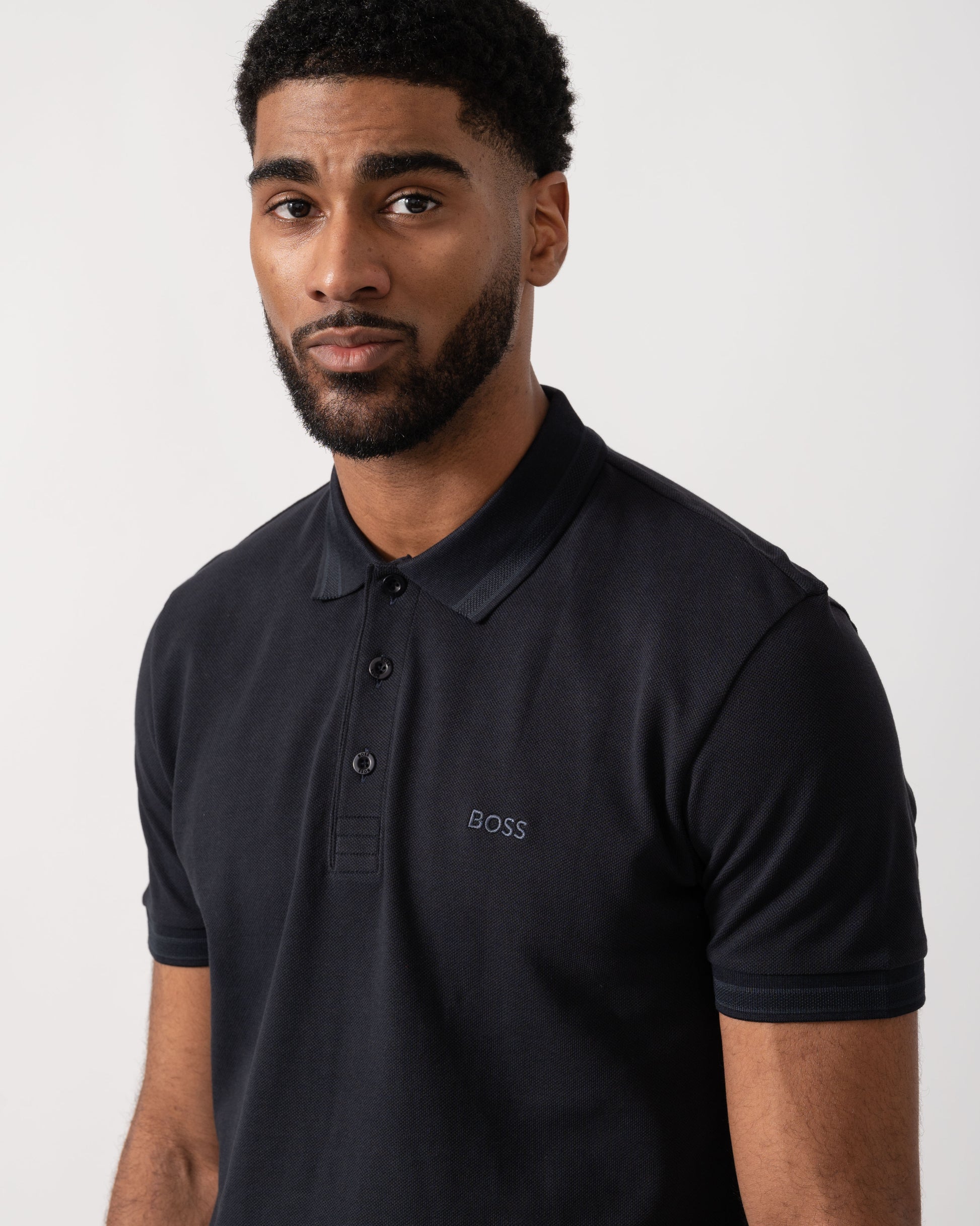 Model wearing BOSS Green Mens Paddy Cotton-Piqué Polo Shirt with Contrast Logo in Dark Blue 408 - Detail