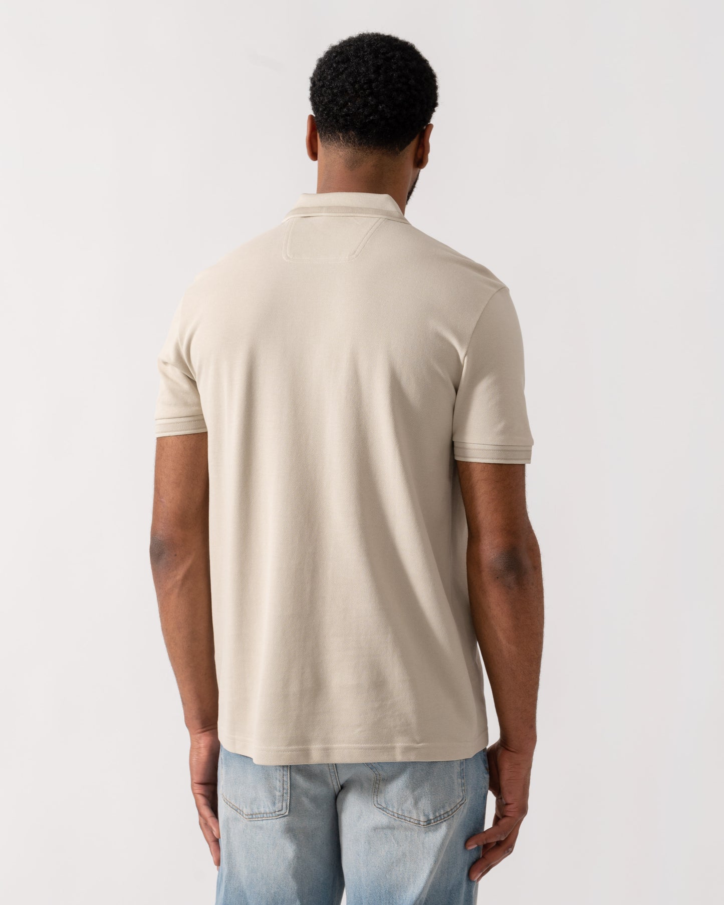 Model wearing BOSS Green Mens Paddy Cotton-Piqué Polo Shirt with Contrast Logo in Light Beige 275 - back