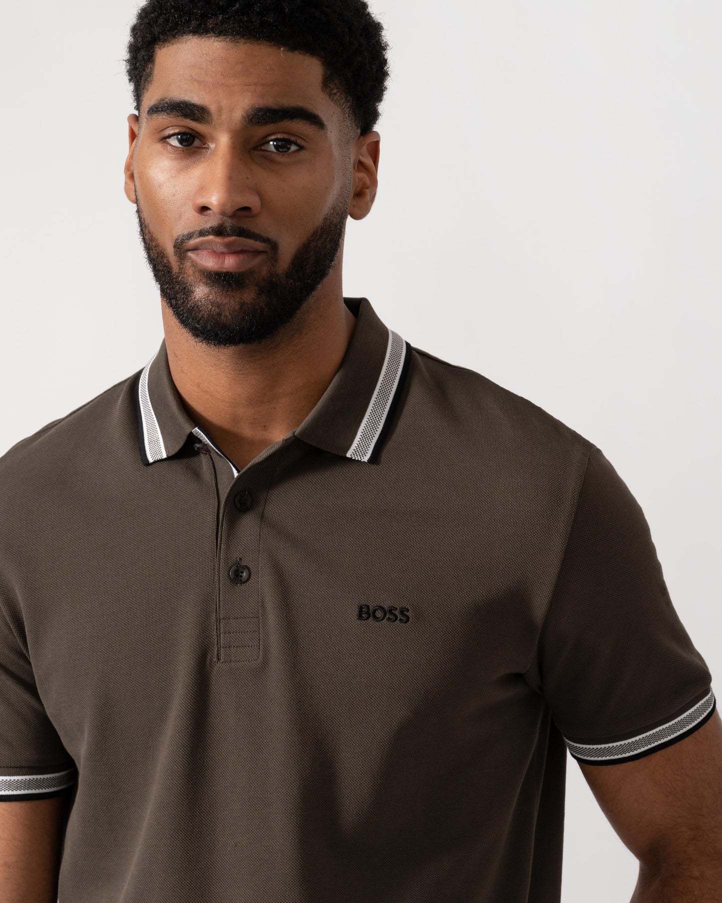 Model wearing BOSS Green Mens Paddy Cotton-Piqué Polo Shirt with Contrast Logo in Open Beige 297 - detail