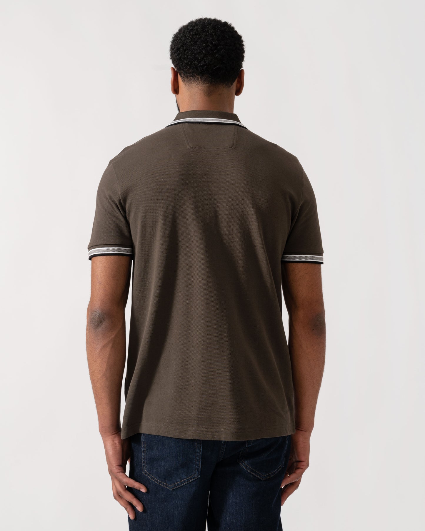 Model wearing BOSS Green Mens Paddy Cotton-Piqué Polo Shirt with Contrast Logo in Open Beige 297 - back