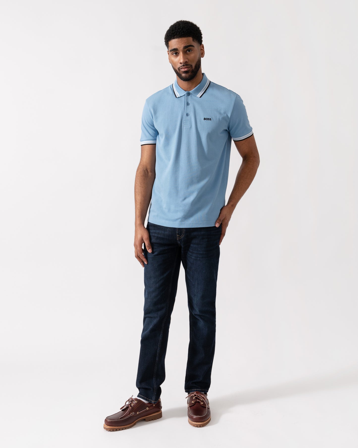 Model wearing BOSS Green Mens Paddy Cotton-Piqué Polo Shirt with Contrast Logo in Open Blue 469 - Full length