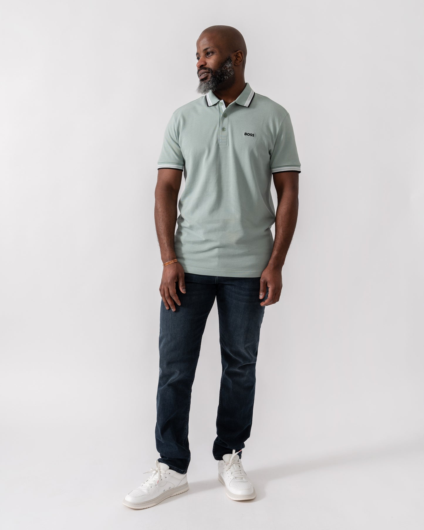 Model wearing BOSS Green Paddy Mens Cotton-Piqué Polo Shirt with Contrast Logo in Open Green 360 - Full Length