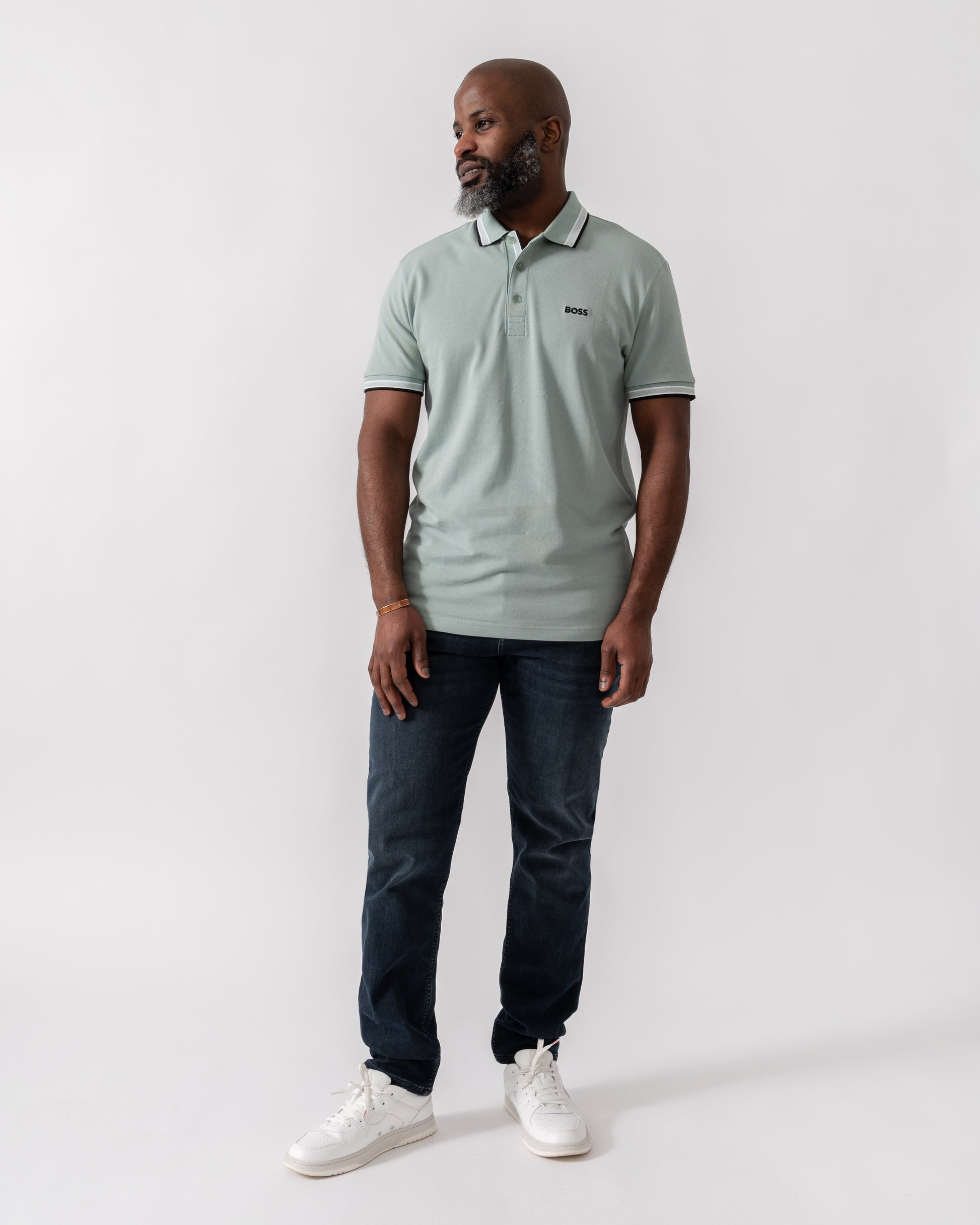 Model wearing BOSS Green Paddy Mens Cotton-Piqué Polo Shirt with Contrast Logo in Open Green 360 - Full Length