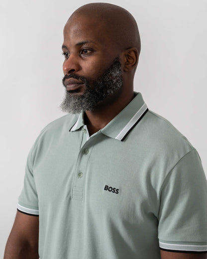 Model wearing BOSS Green Paddy Mens Cotton-Piqué Polo Shirt with Contrast Logo in Open Green 360 - Collar detail