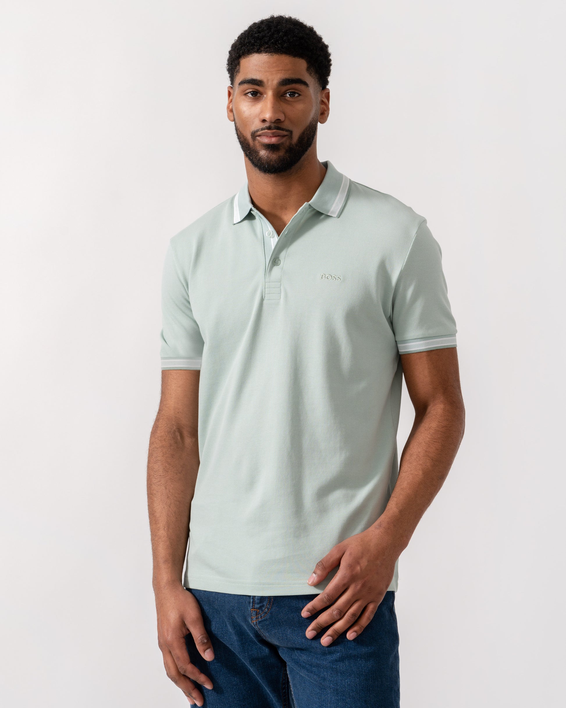 Model wearing BOSS Green Mens Paddy Cotton-Piqué Polo Shirt with Contrast Logo in Turquoise/Aqua 448 - Main