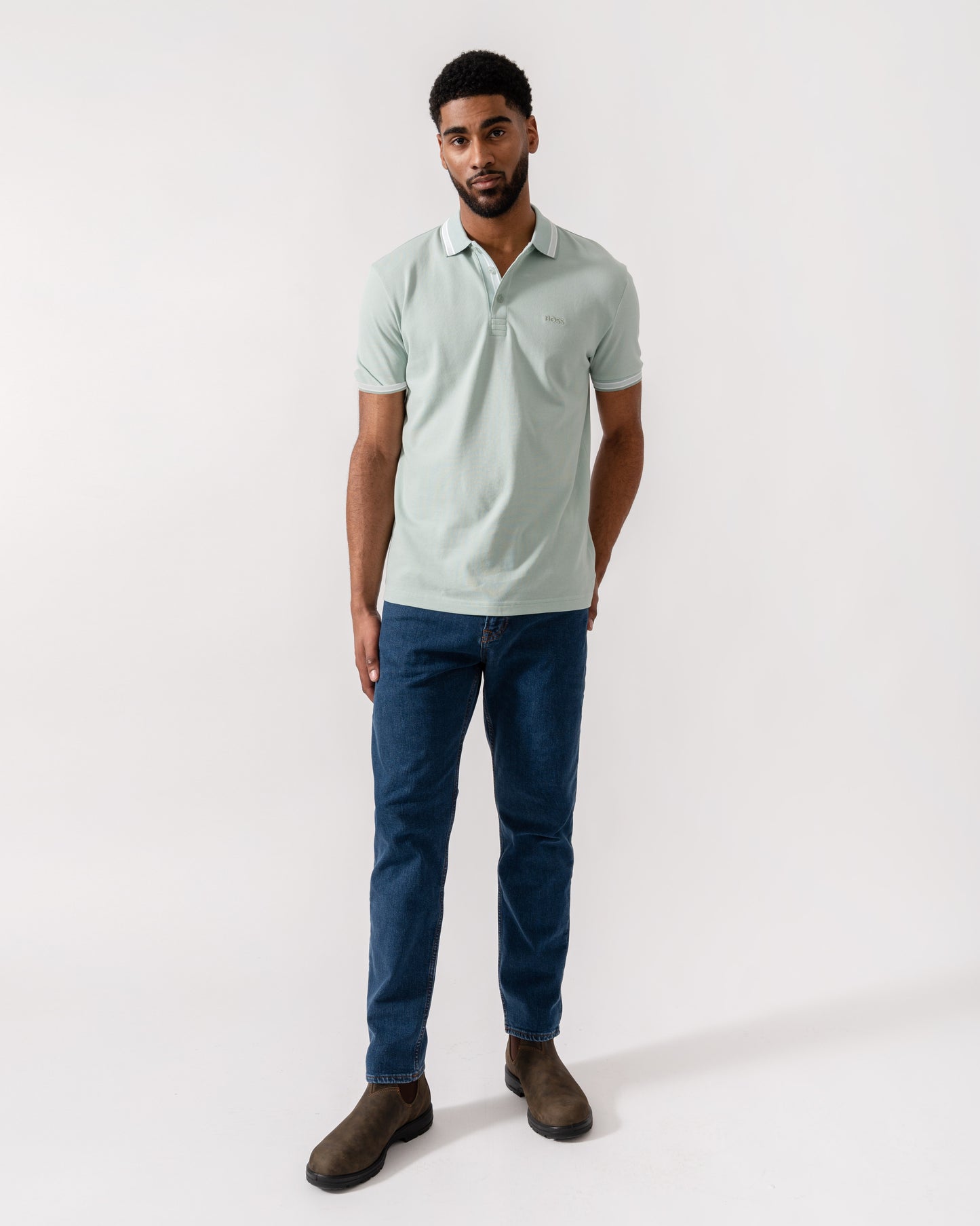 Model wearing BOSS Green Mens Paddy Cotton-Piqué Polo Shirt with Contrast Logo in Turquoise/Aqua 448 - Full Length