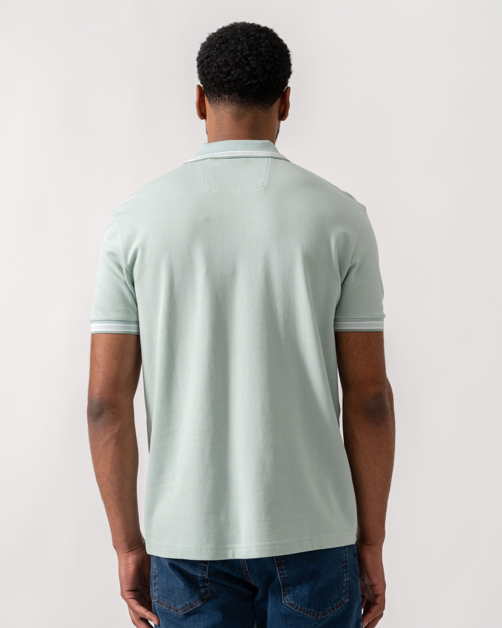 Model wearing BOSS Green Mens Paddy Cotton-Piqué Polo Shirt with Contrast Logo in Turquoise/Aqua 448 - Back