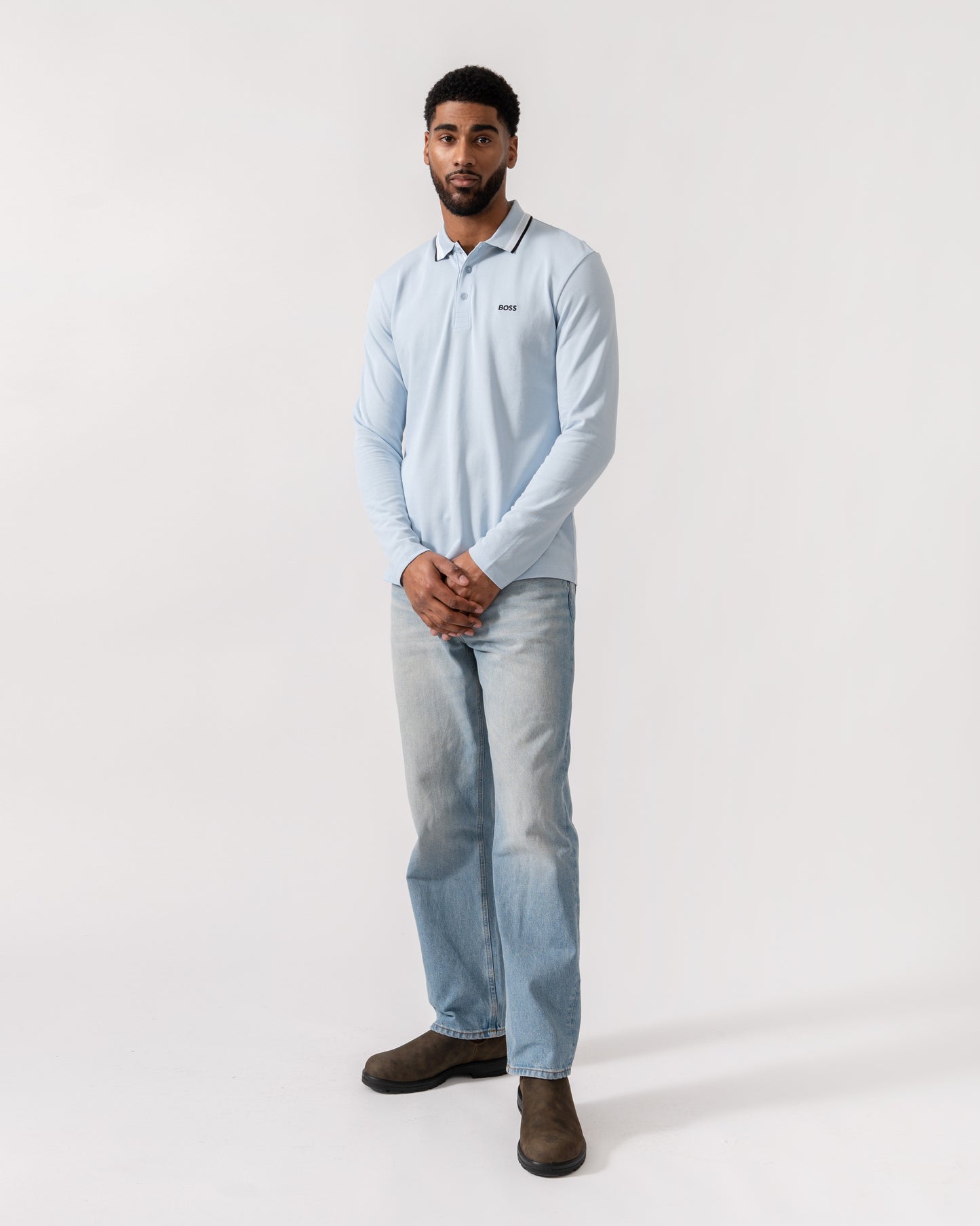 Model wearing BOSS Green Mens Plisy Long Sleeve Polo Shirt in Open Blue 464 - Full Length