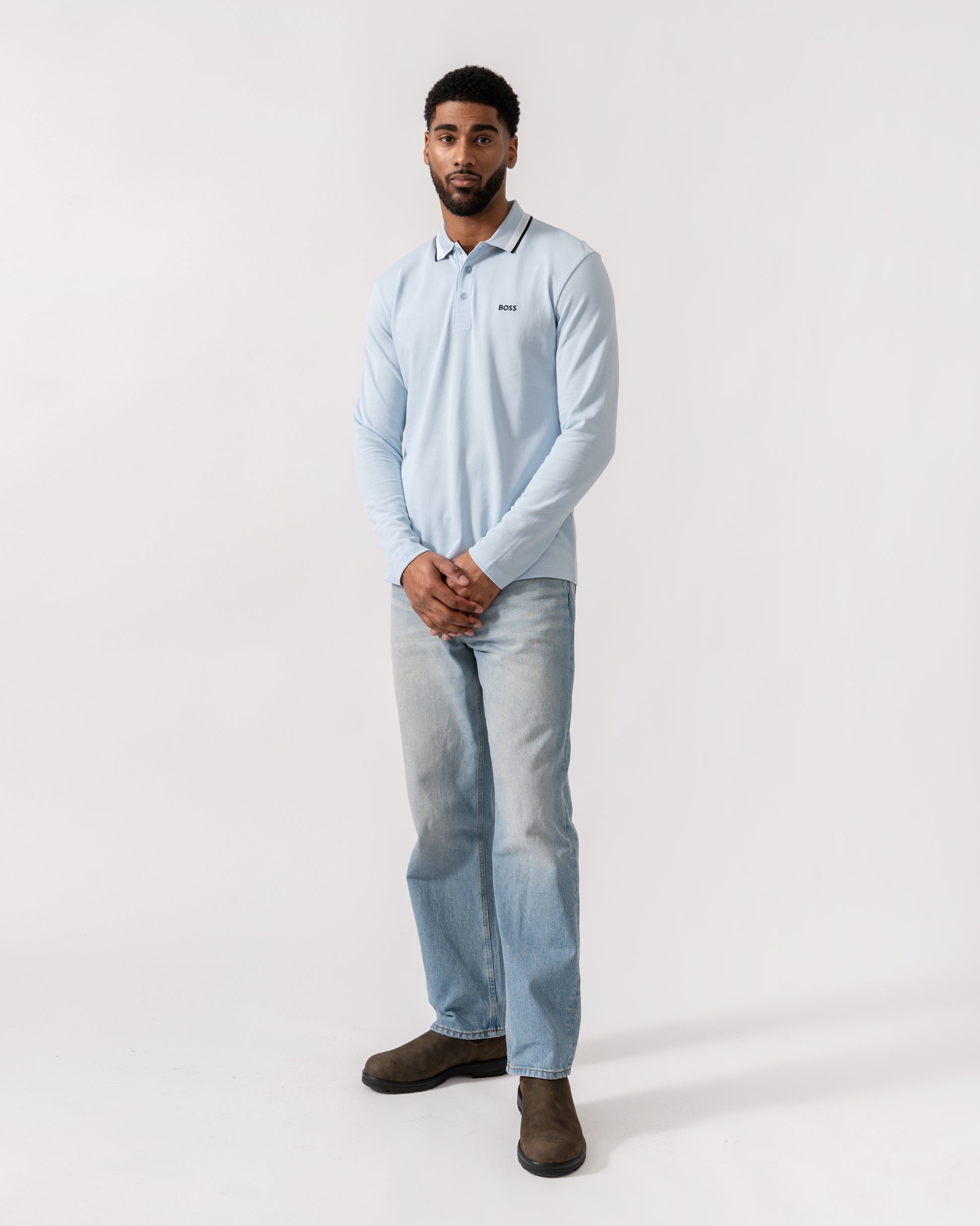 Model wearing BOSS Green Mens Plisy Long Sleeve Polo Shirt in Open Blue 464 - Full Length