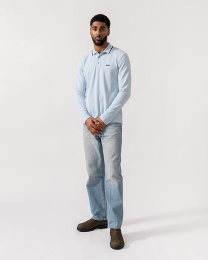 Model wearing BOSS Green Mens Plisy Long Sleeve Polo Shirt in Open Blue 464 - Full Length