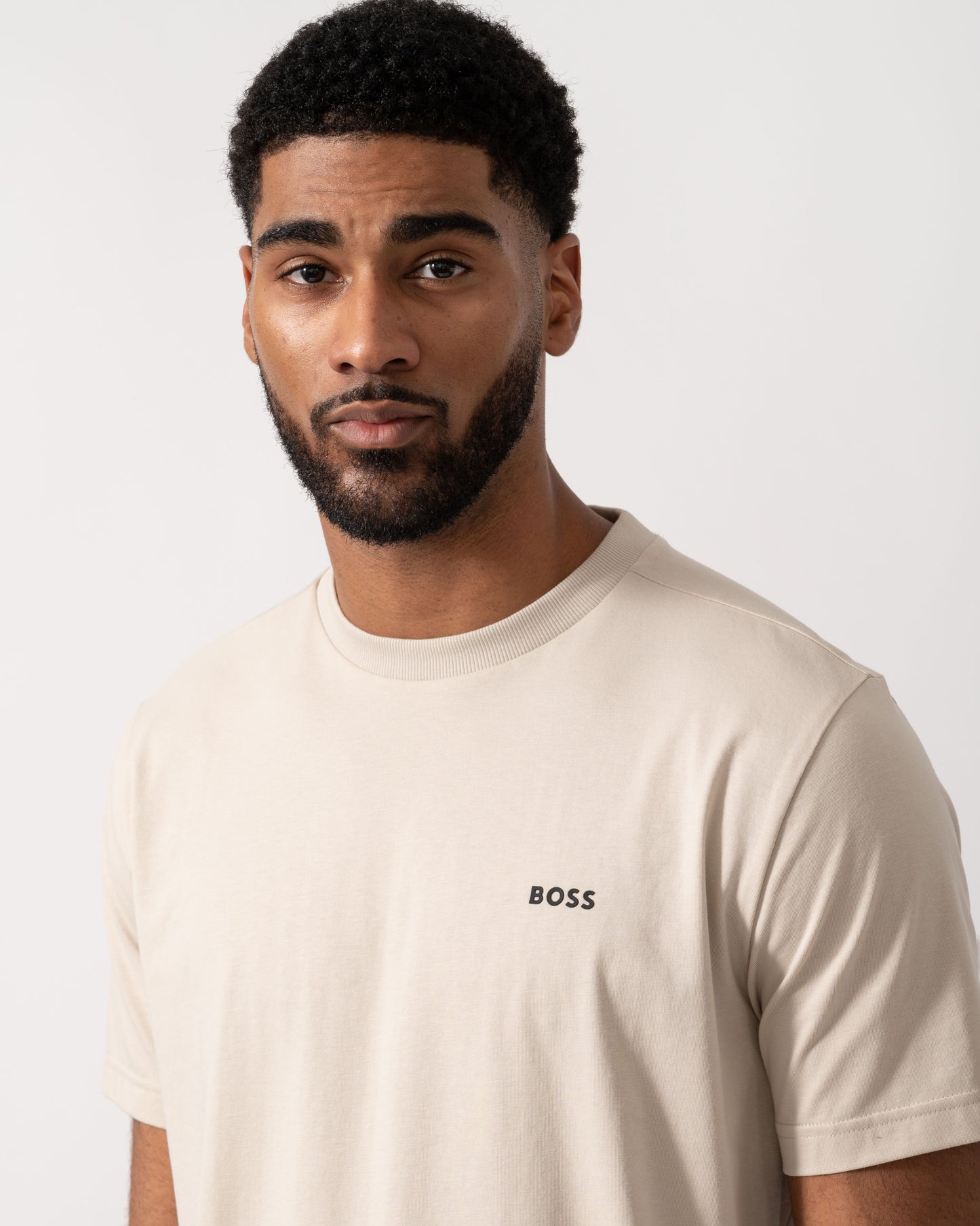 Model wearing BOSS Green Mens Tee Stretch Cotton T-Shirt with Contrast Logo in Light Beige 275 - detail