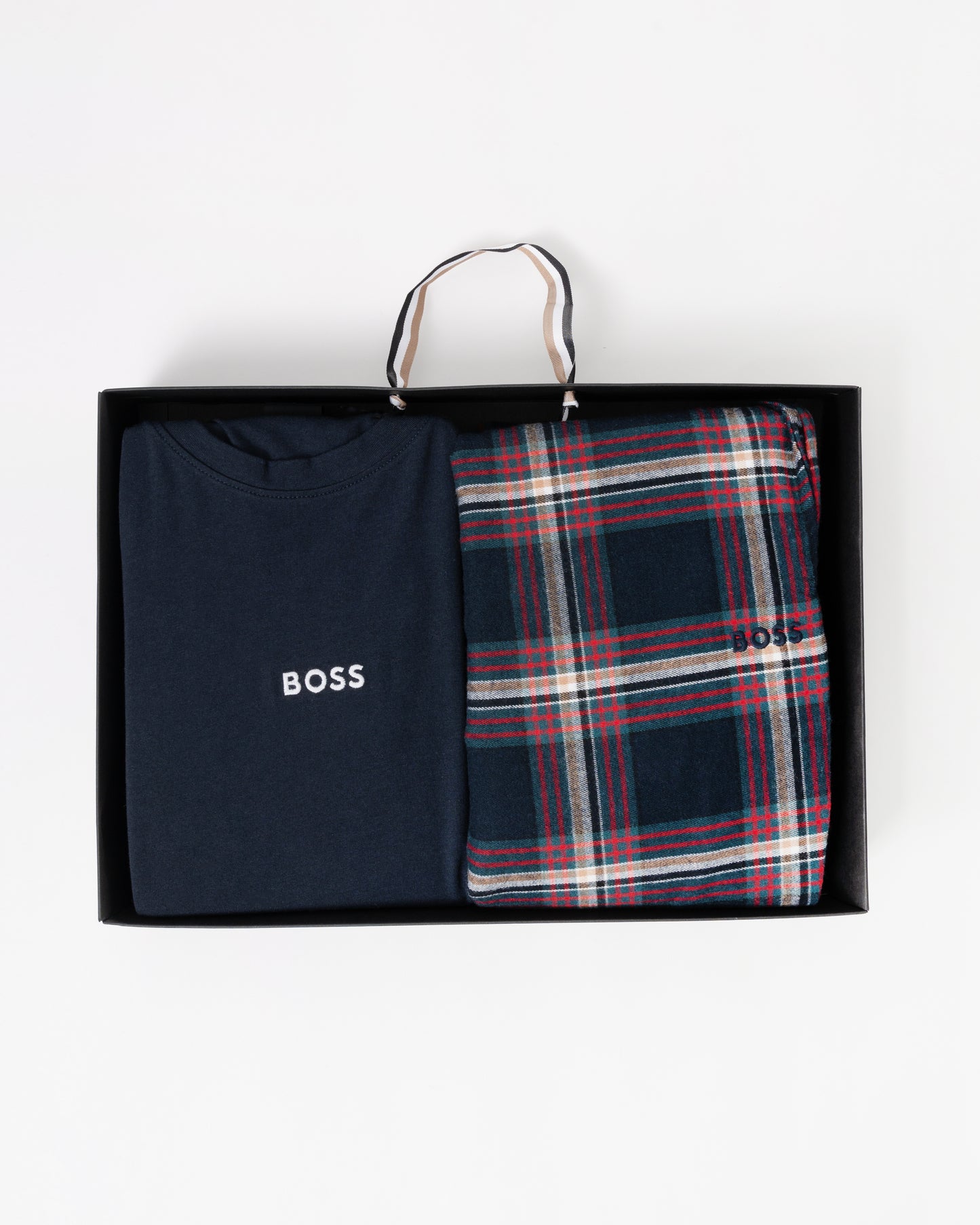 Navy t-shirt and plaid towel in a black box with 'BOSS' branding on a white background