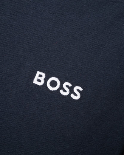 Close-up of a black fabric with 'BOSS' embroidered in white.