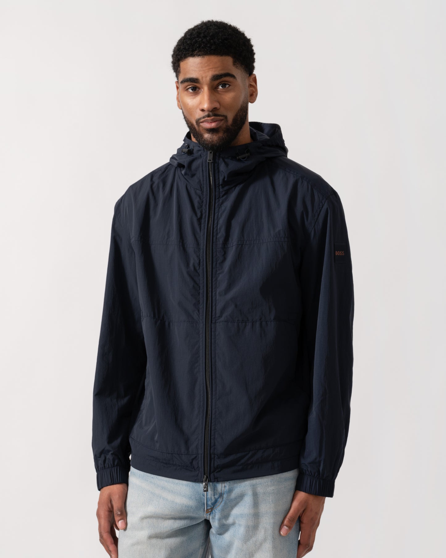 Model wearing BOSS Orange Orip Hooded Jacket in Dark Blue 404 - Main