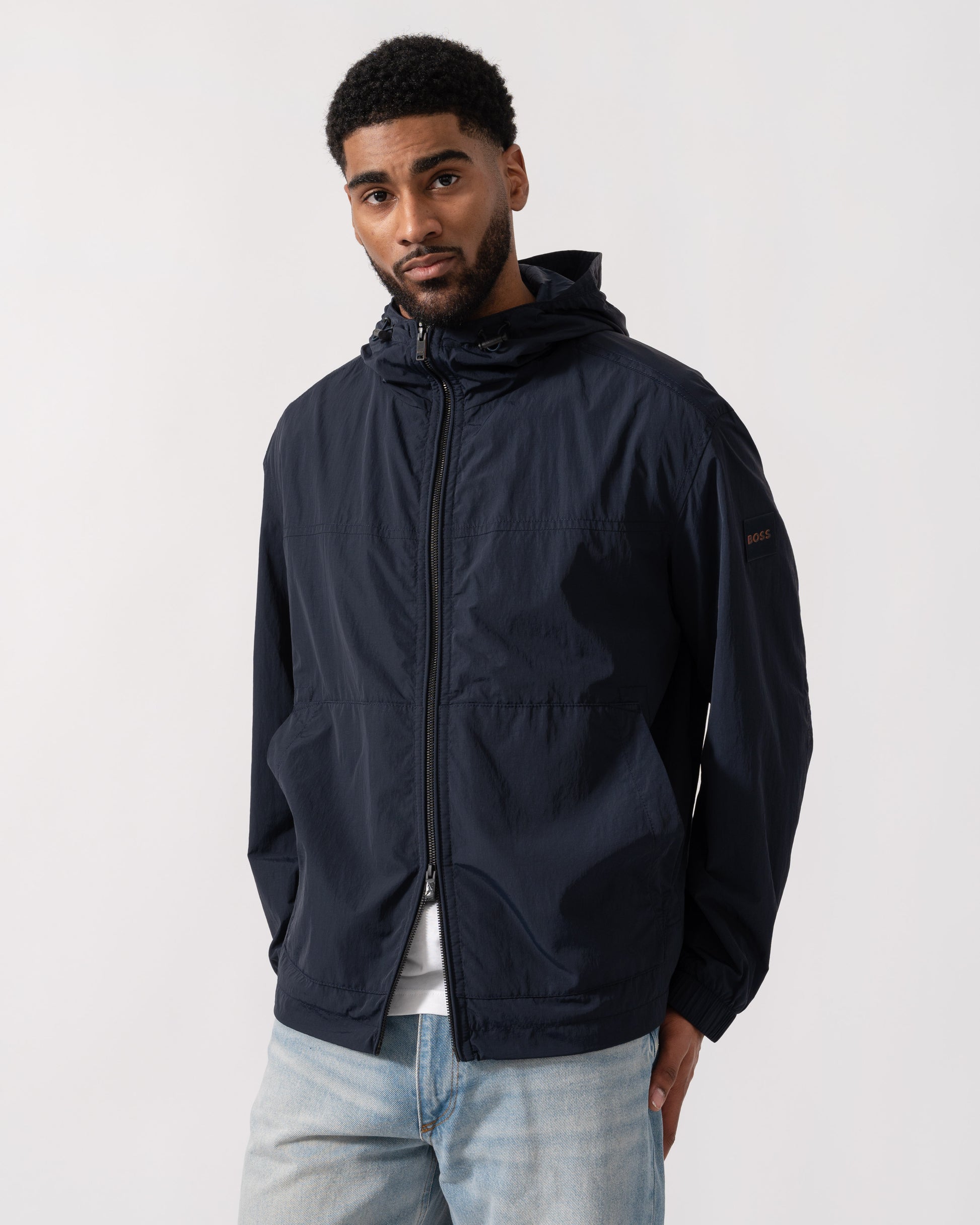 Model wearing BOSS Orange Orip Hooded Jacket in Dark Blue 404 - Double Zip