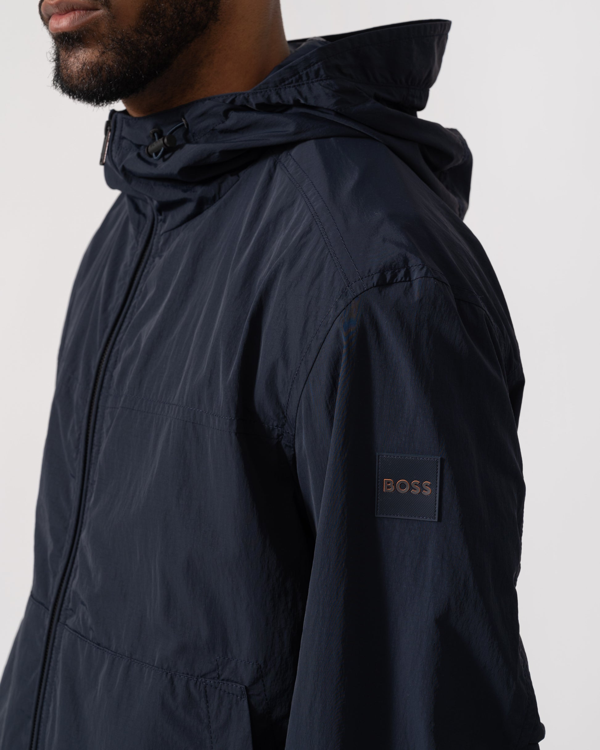 Model wearing BOSS Orange Orip Hooded Jacket in Dark Blue 404 - Detail